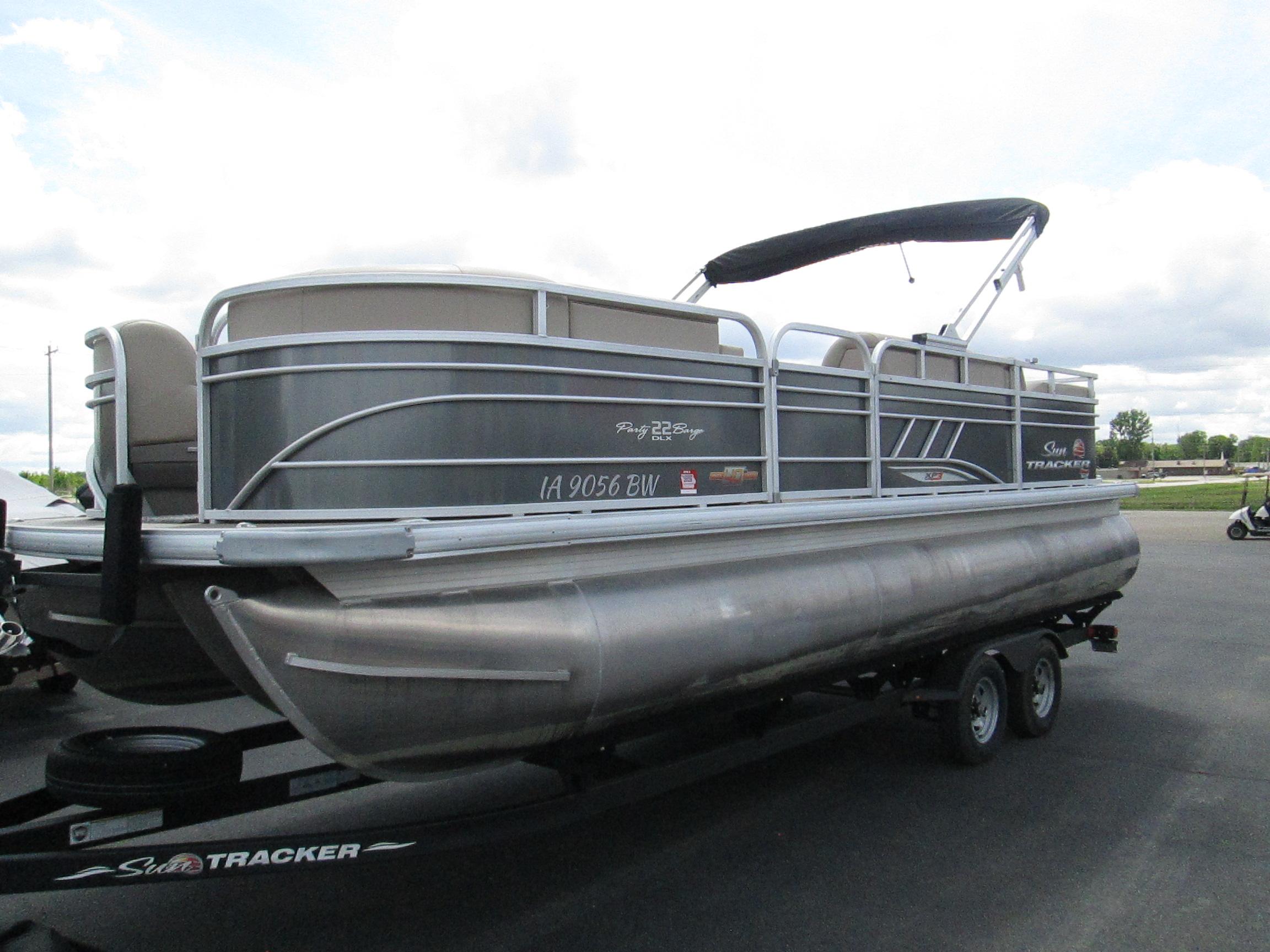 2023 Sun Tracker Party Barge 22 XP3 pontoon boat on trailer, side view.