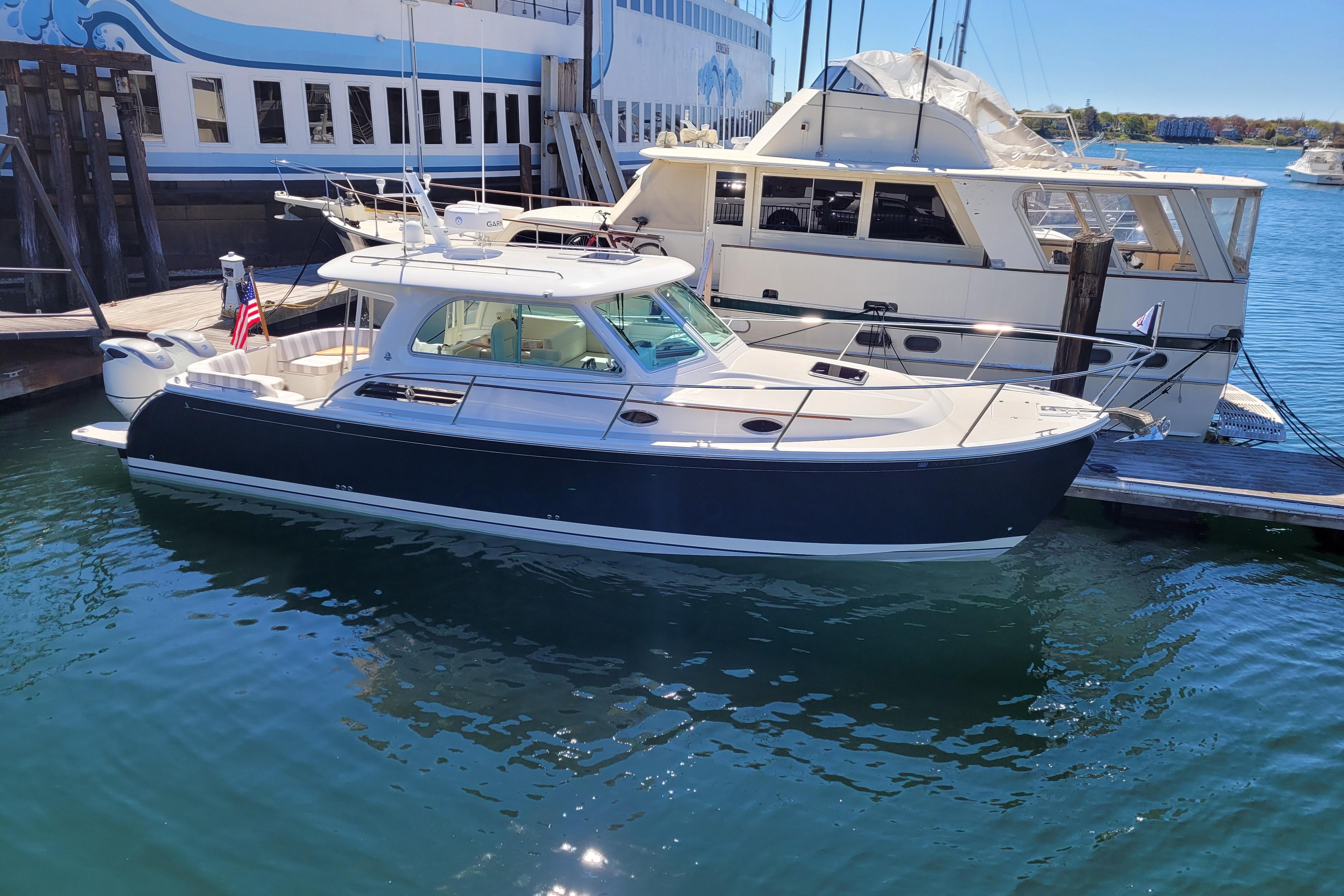 2021 Back Cove 34O boat docked in a marina, featuring sleek design and modern amenities.