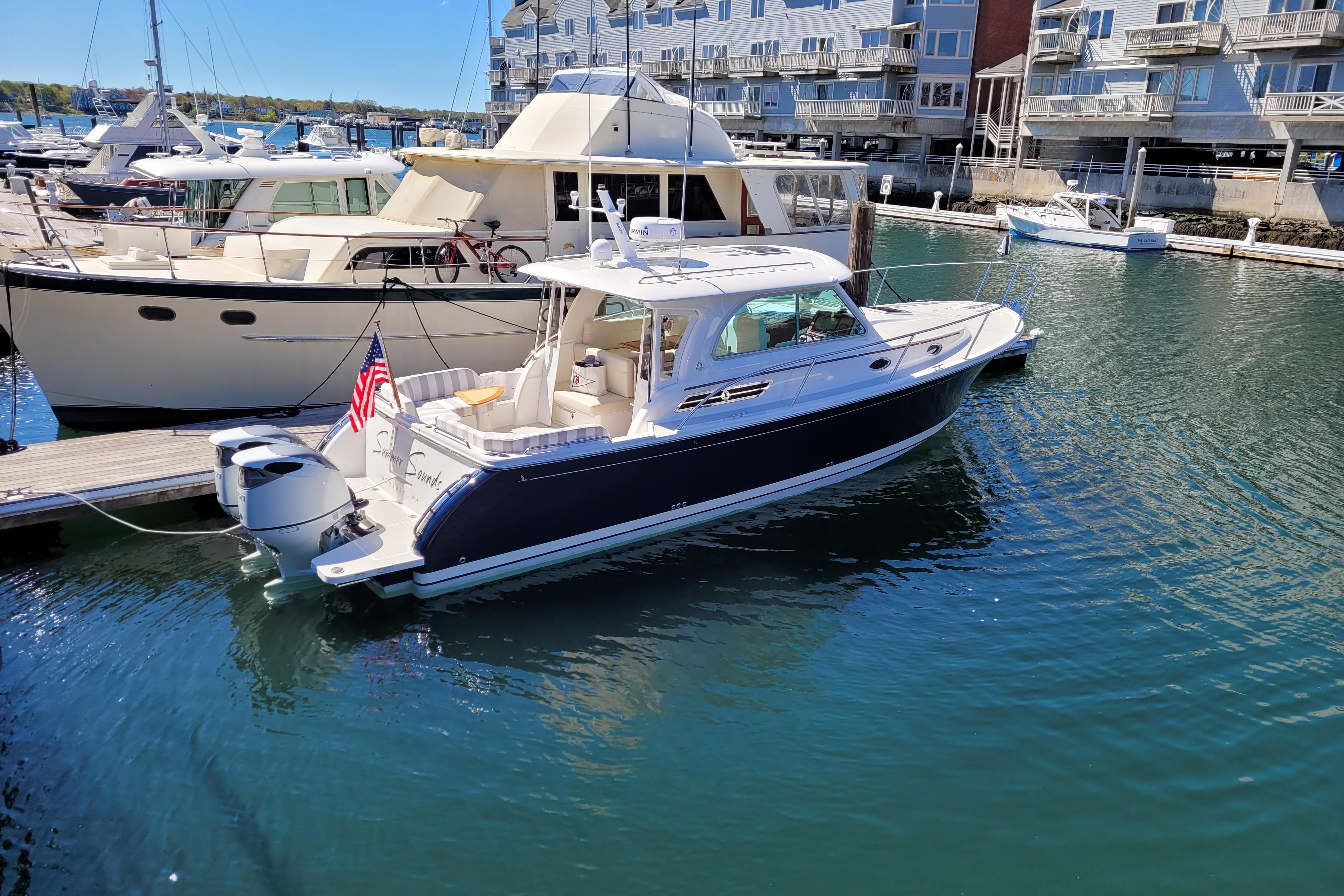 2021 Back Cove 34O boat docked in marina, surrounded by other vessels.