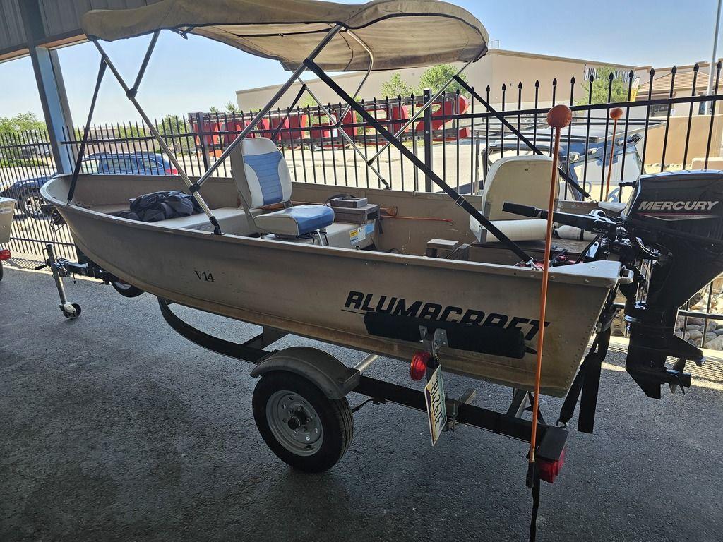 2003 Alumacraft V14 boat with canopy and Mercury outboard motor on trailer.