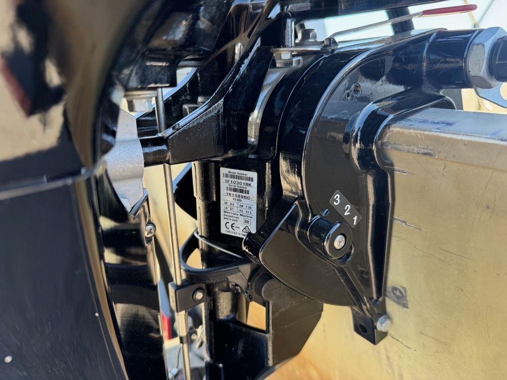 Close-up of a 2003 Alumacraft V14 boat motor mechanism, showing detailed components.