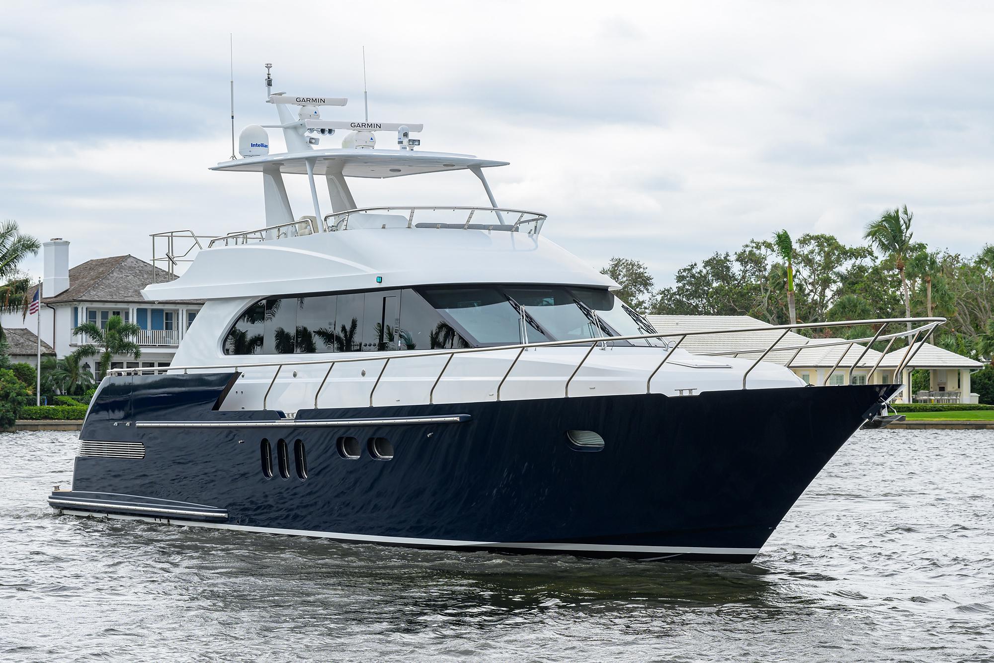 2018 Coastal Craft Concord 65 yacht cruising on a serene waterway.