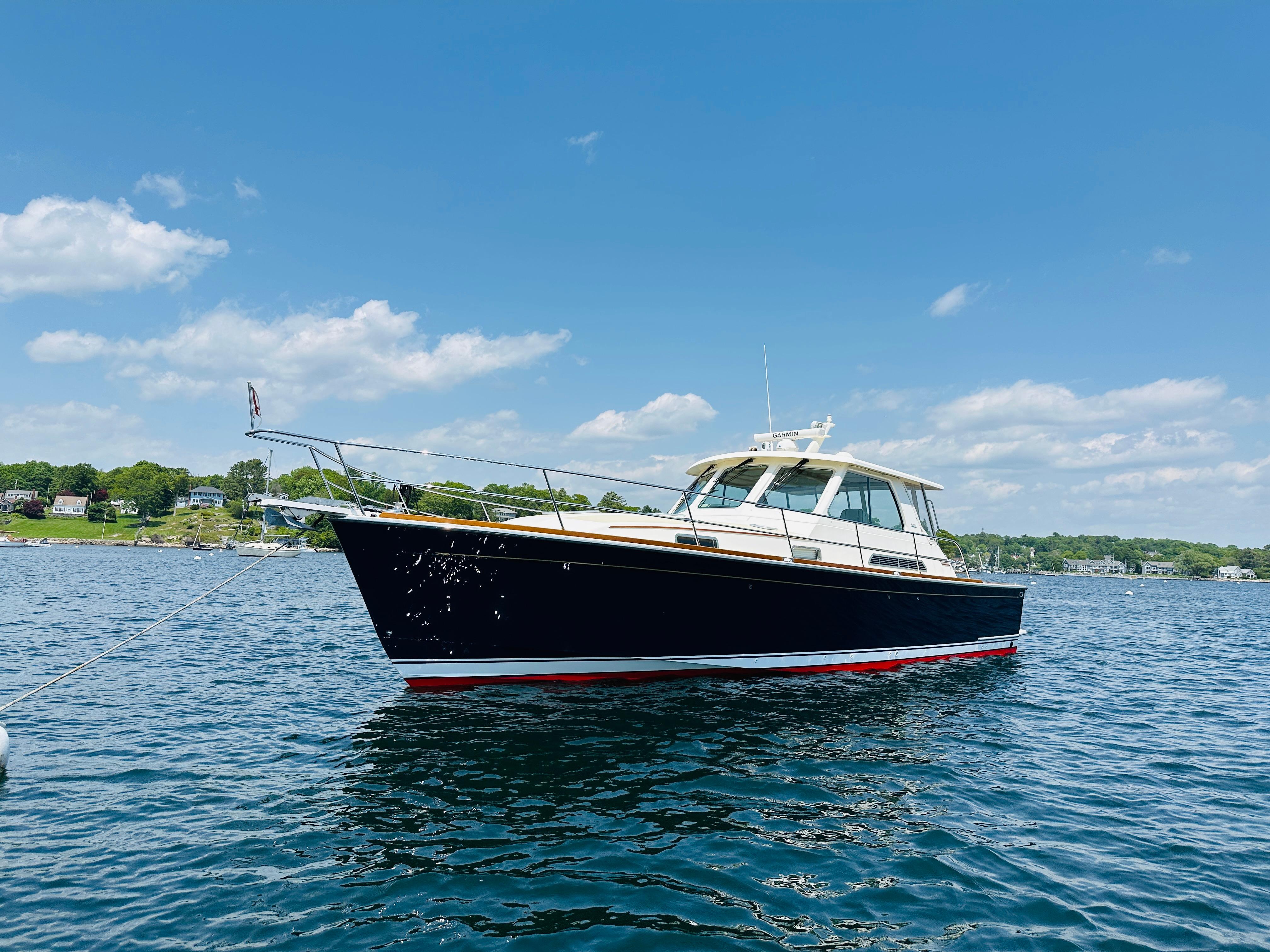 2008 Sabre 42 Hardtop Express yacht on calm water under blue sky.