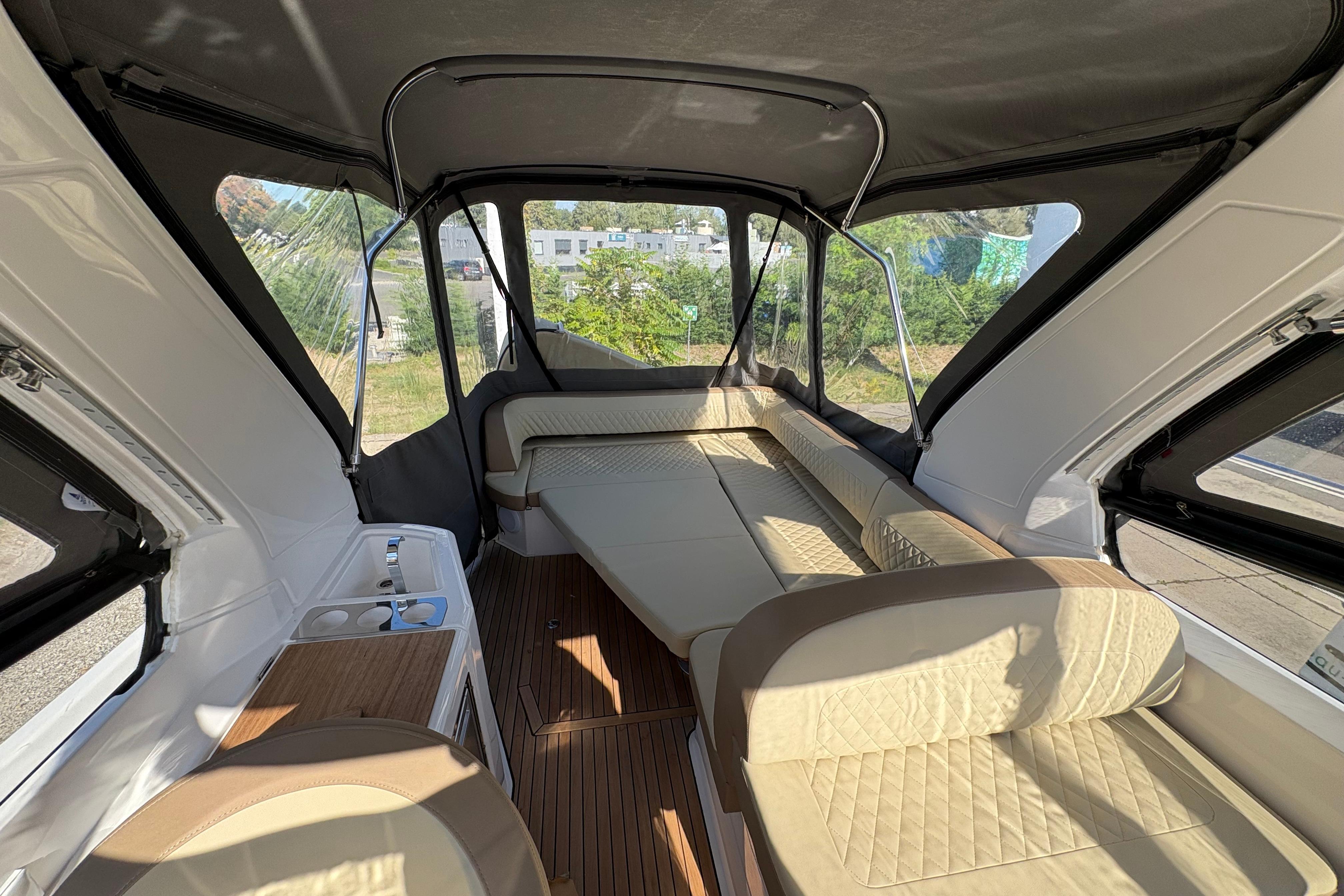 2023 Bavaria S30 Open interior with beige seating and kitchenette, showcasing luxury design.