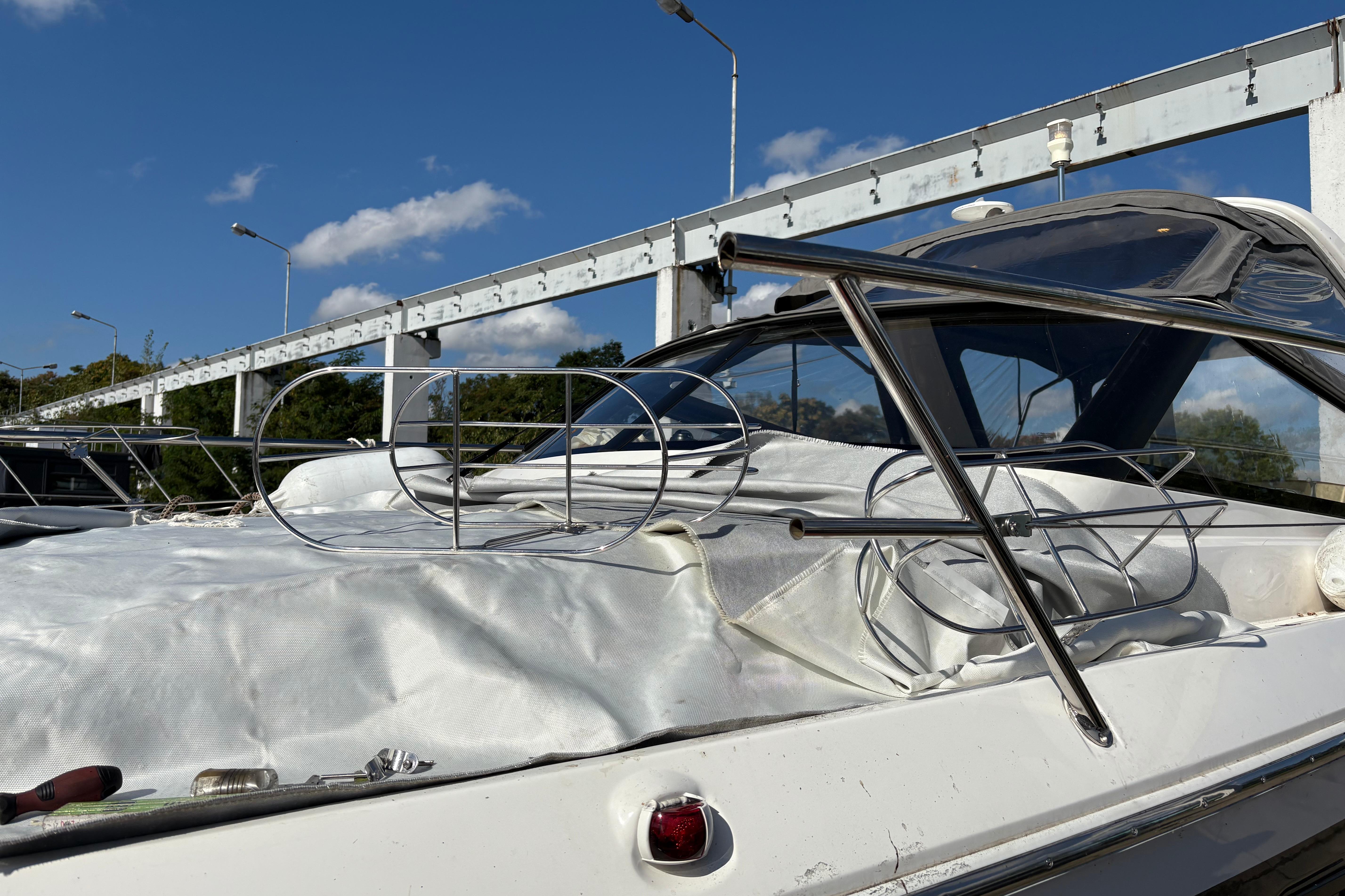 2023 Bavaria S30 Open boat with metal framework, docked under a clear blue sky.