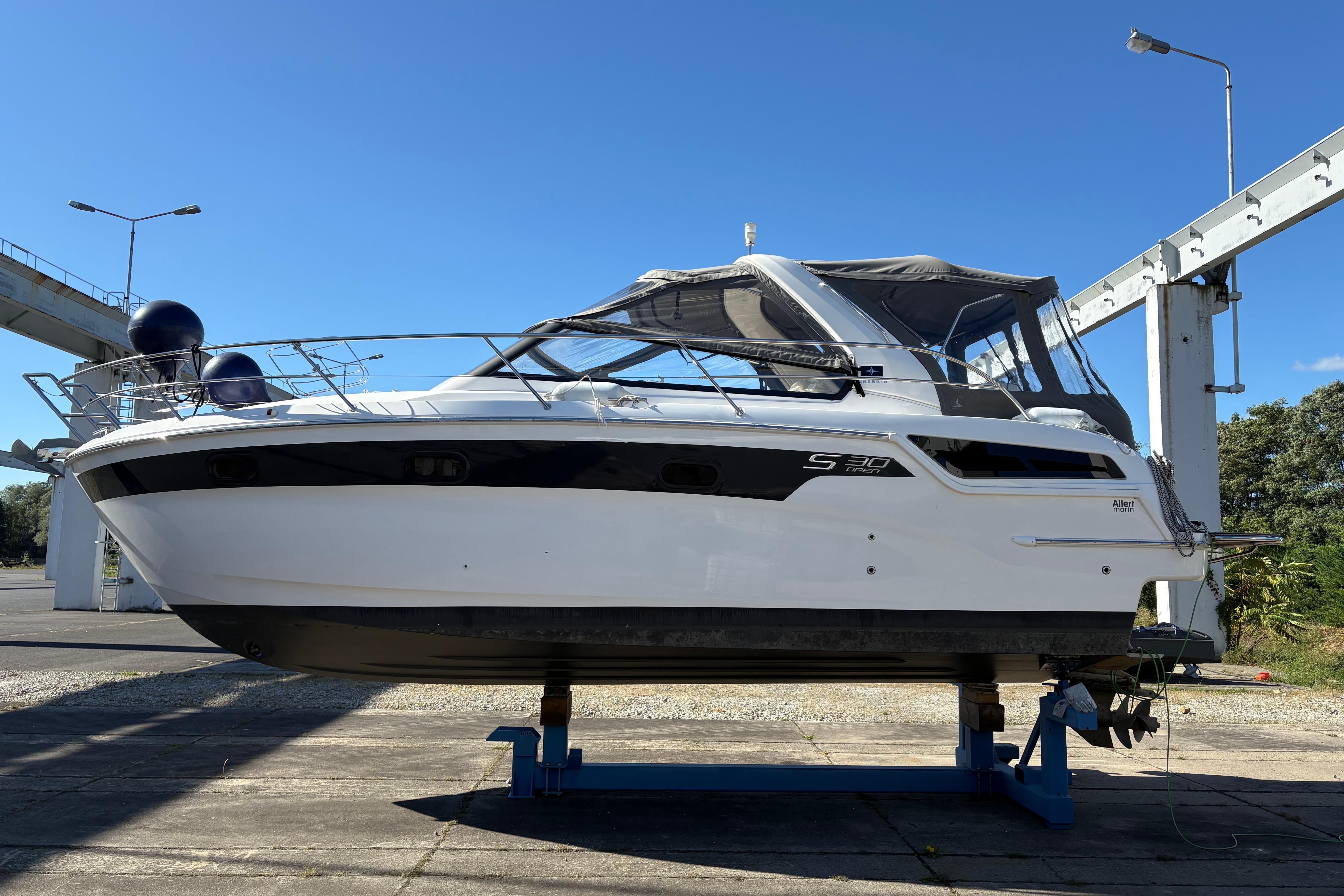 2023 Bavaria S30 Open yacht on a stand under clear blue sky.