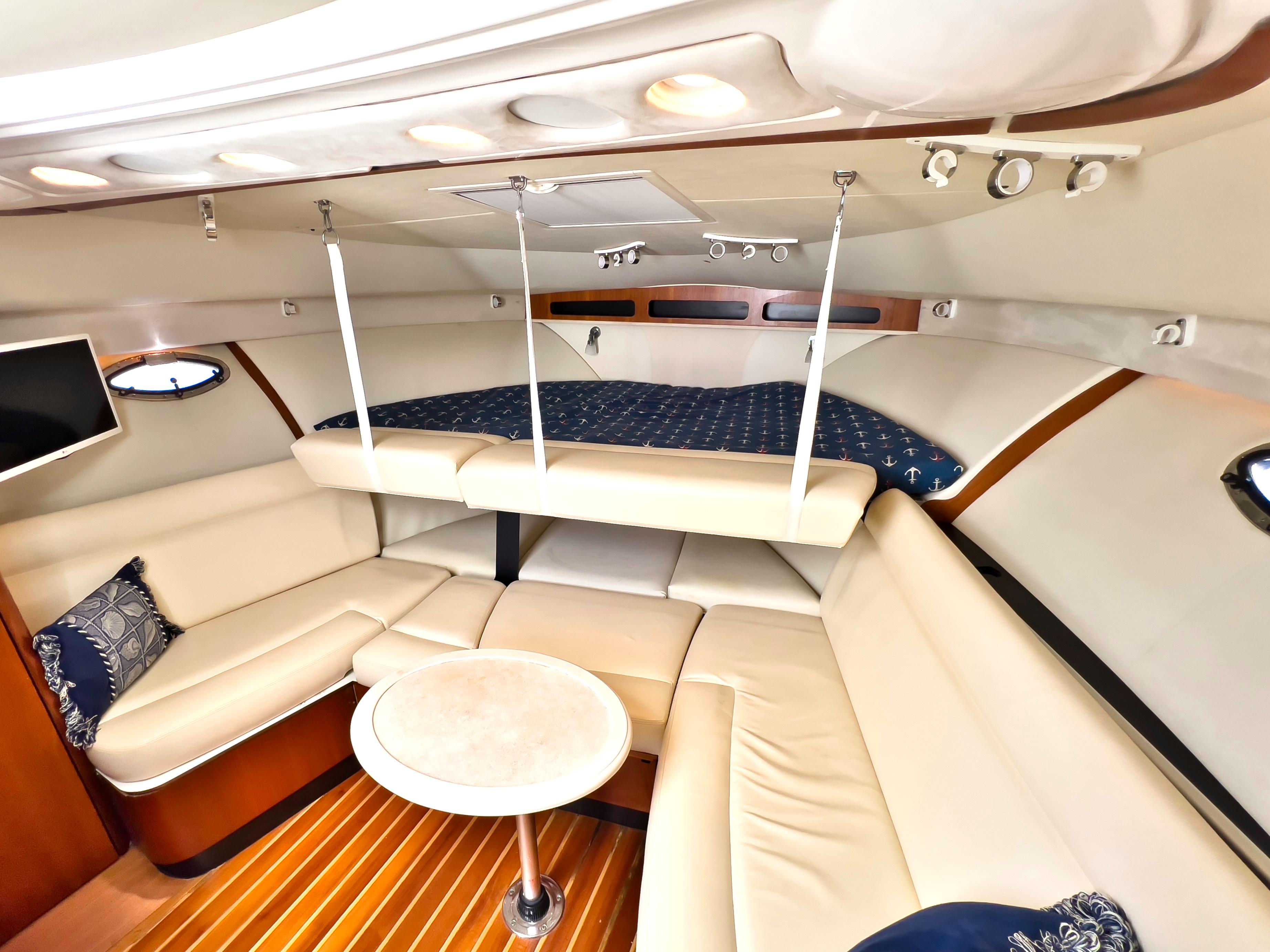 Tiara 30 Seafari - Interior Cabin, Seating with Backrests Folded Upward to Extend Berth, Table and