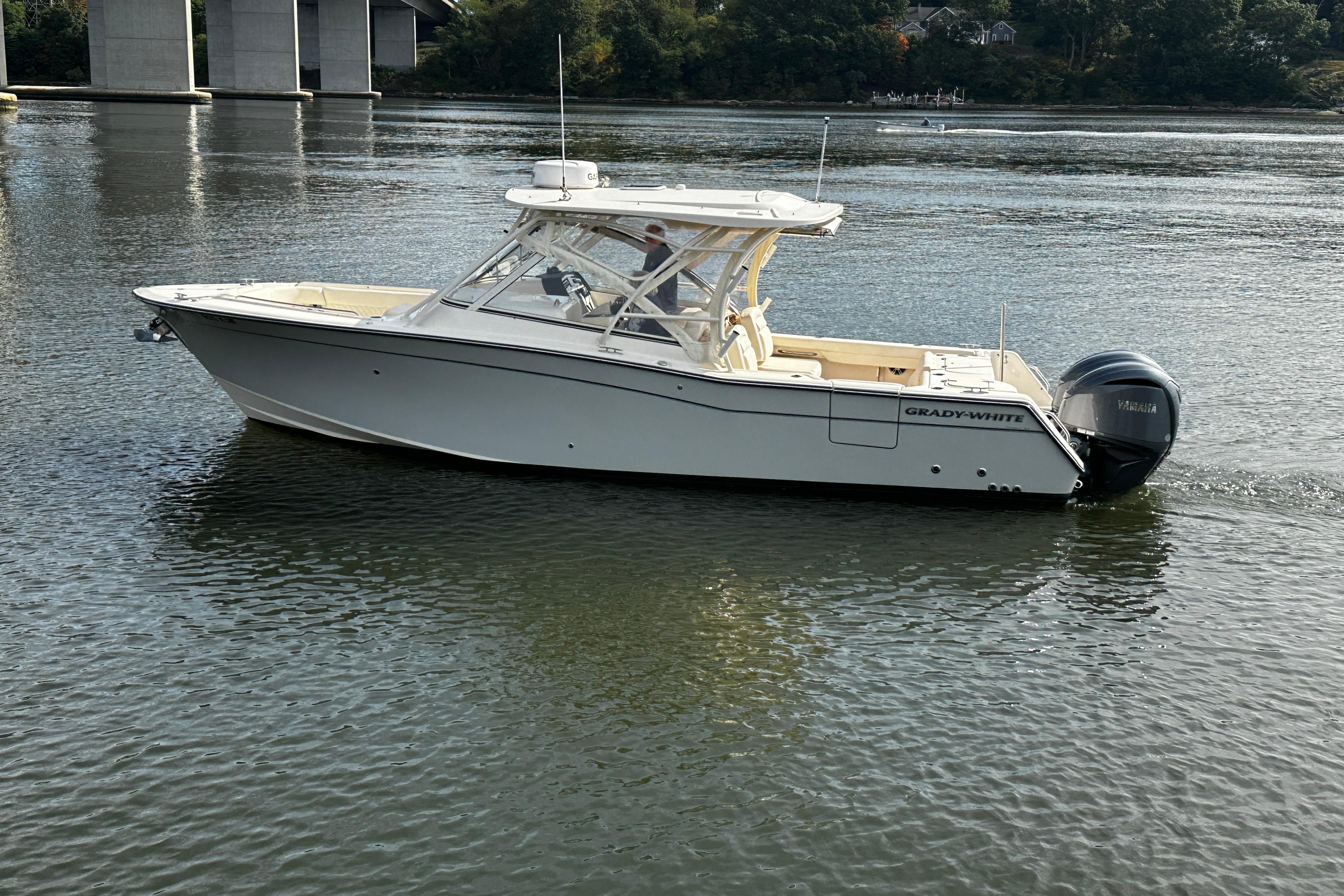 2023 Grady-White Freedom 307 boat cruising on a calm river.