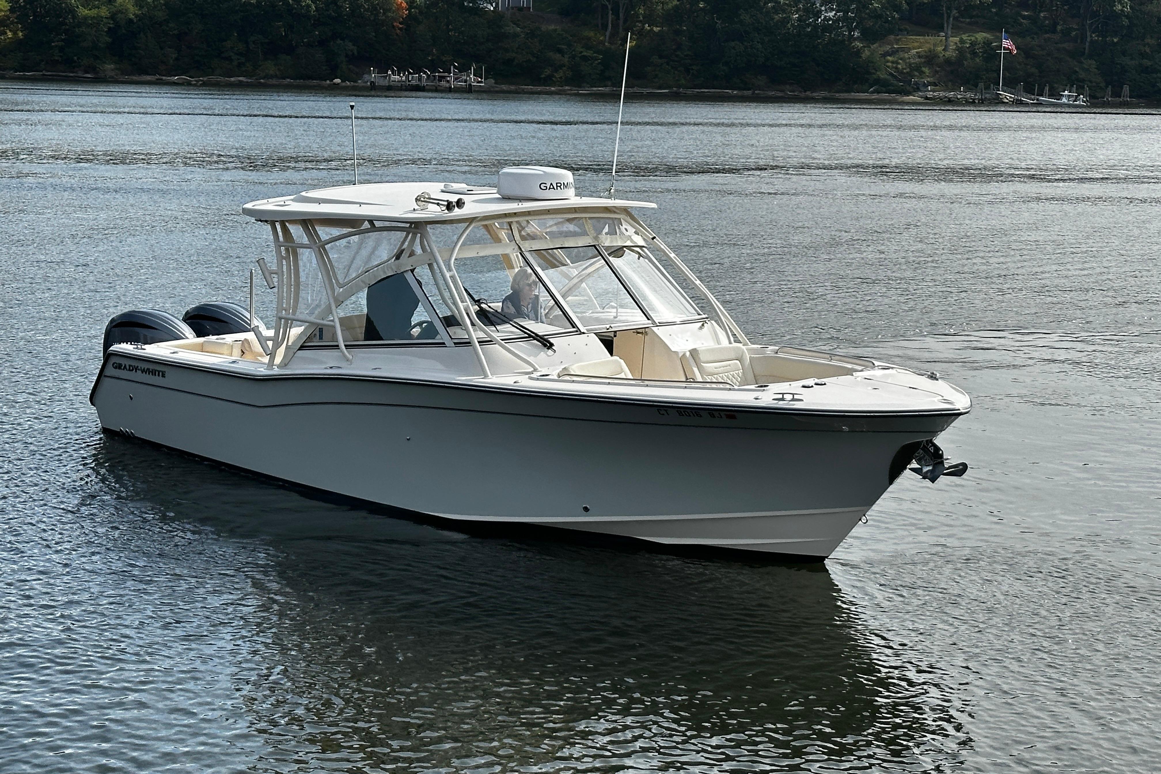 2023 Grady-White Freedom 307 boat on calm water, showcasing sleek design and modern features.