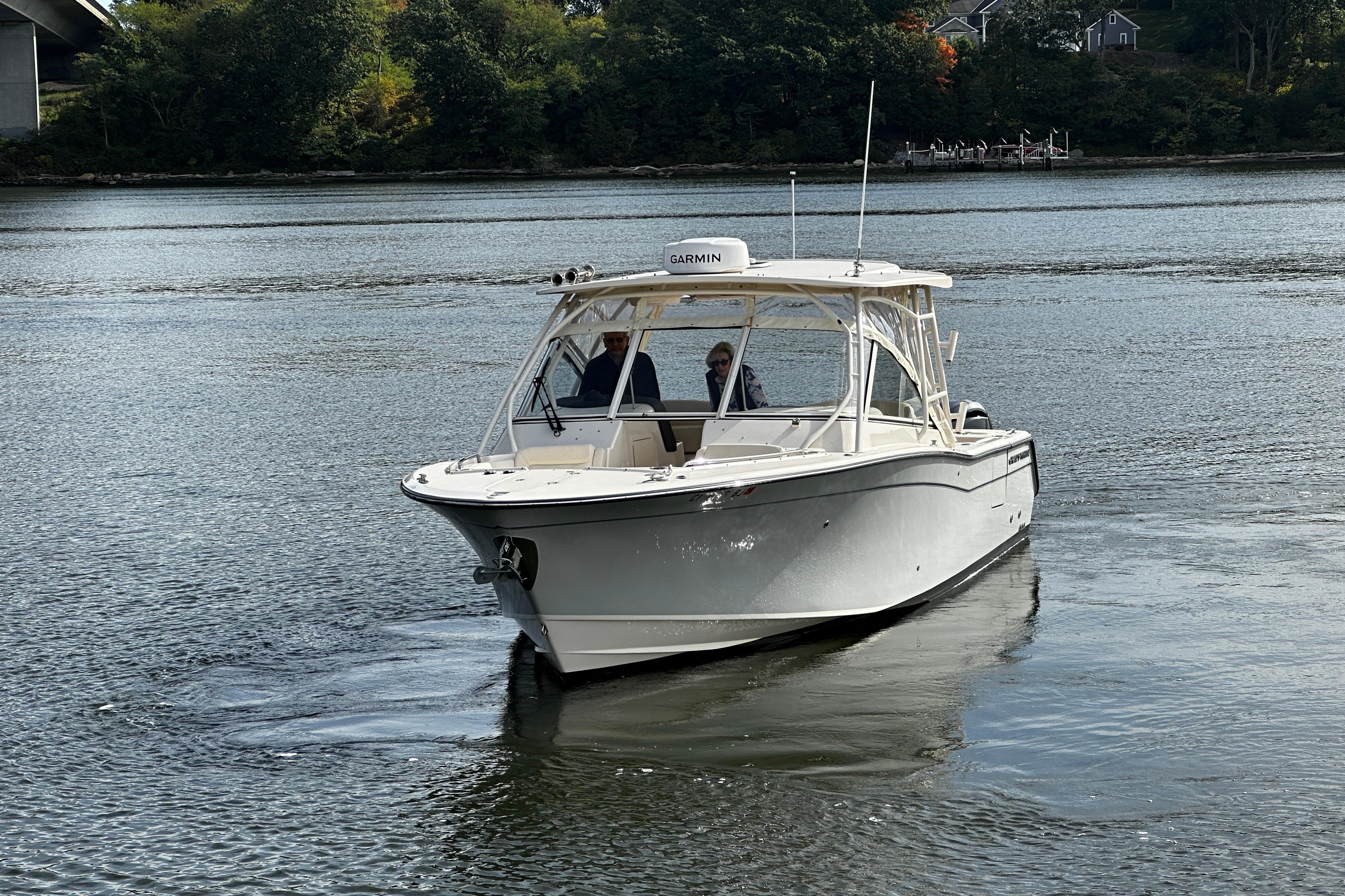 2023 Grady-White Freedom 307 boat cruising on a calm river.