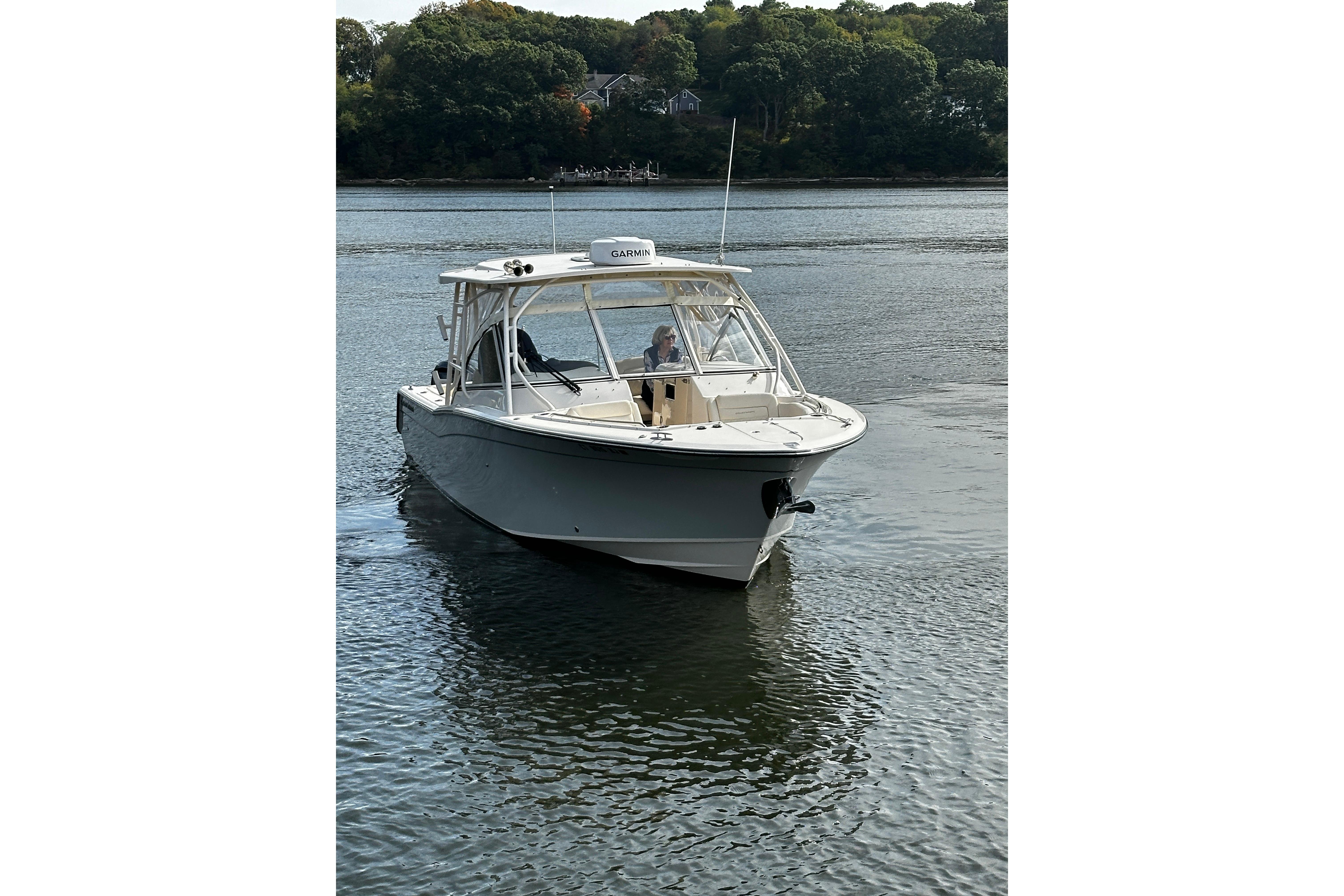 2023 Grady-White Freedom 307 boat cruising on a calm river.