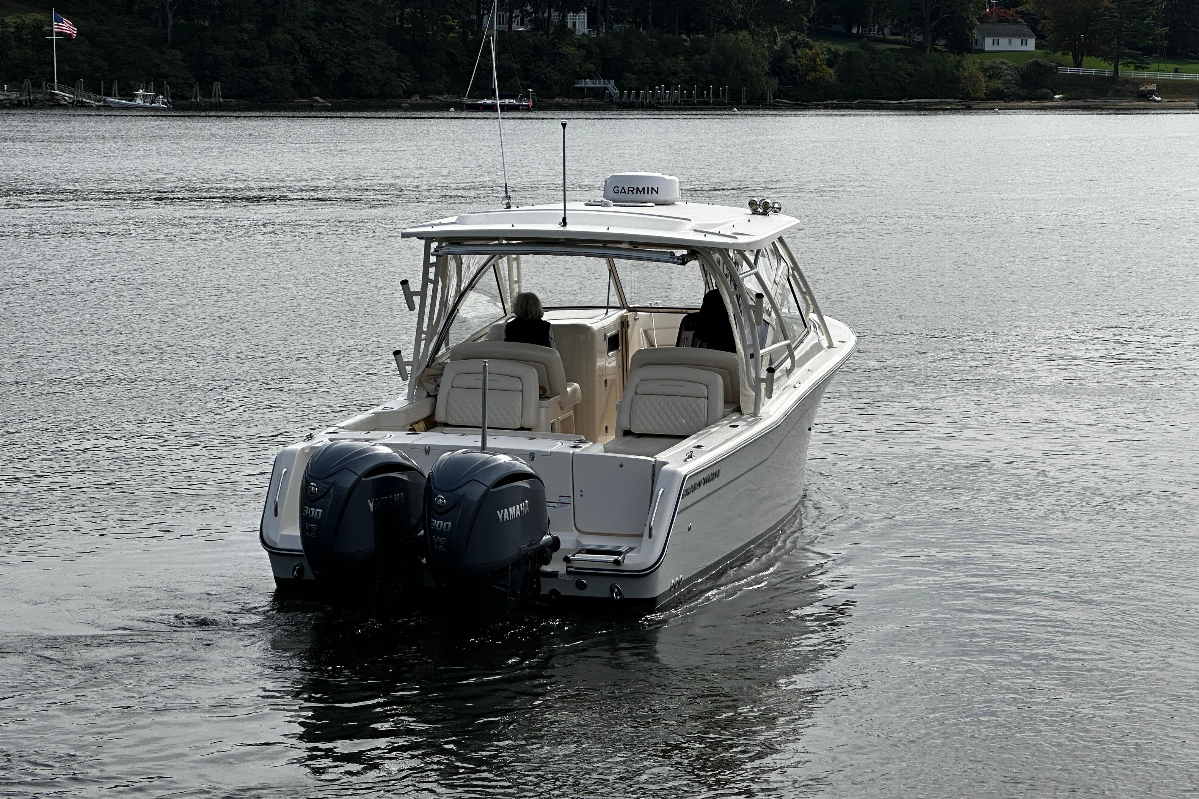 2023 Grady-White Freedom 307 boat with dual Yamaha engines on a calm lake.