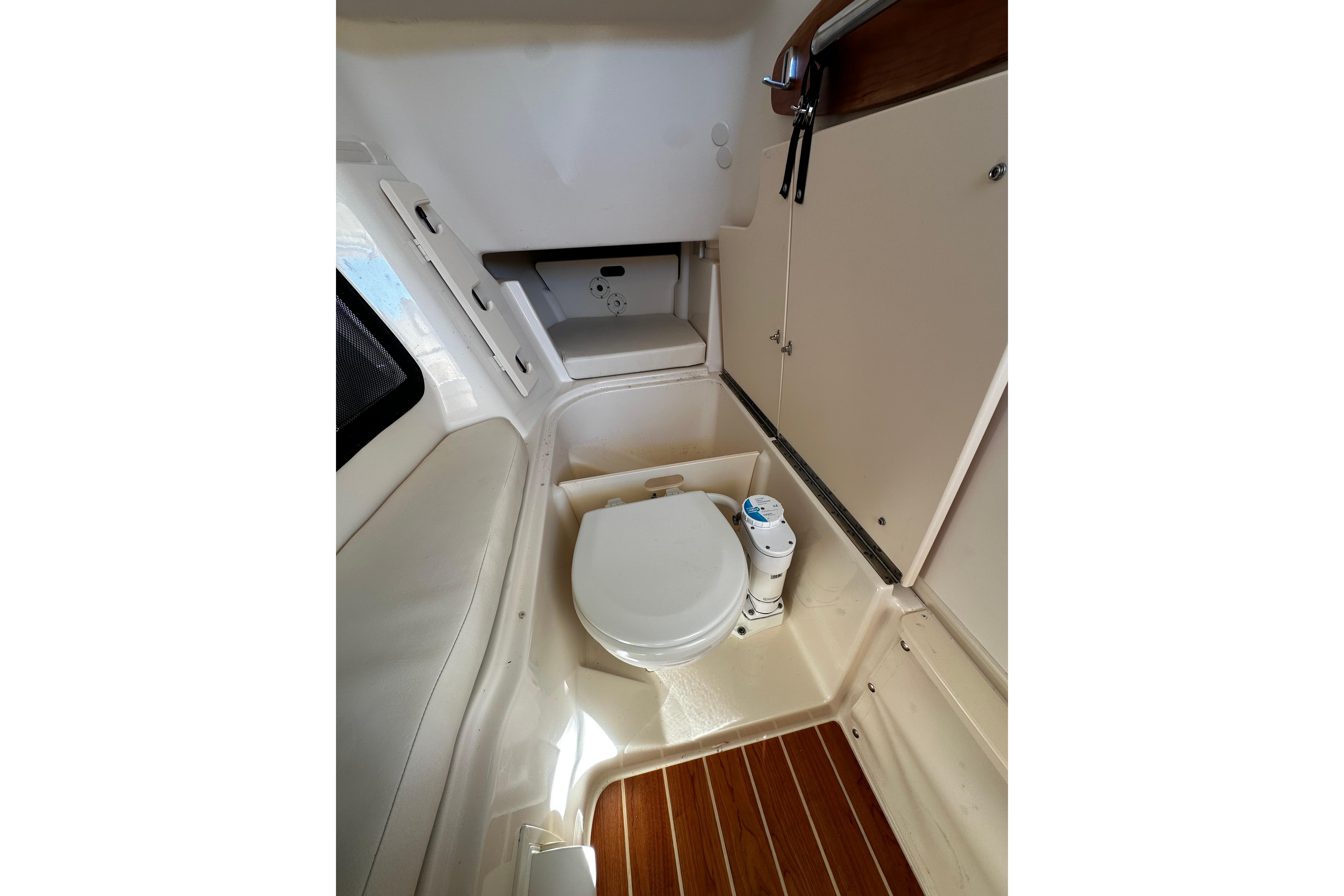 2023 Grady-White Freedom 307 boat interior with compact marine toilet.