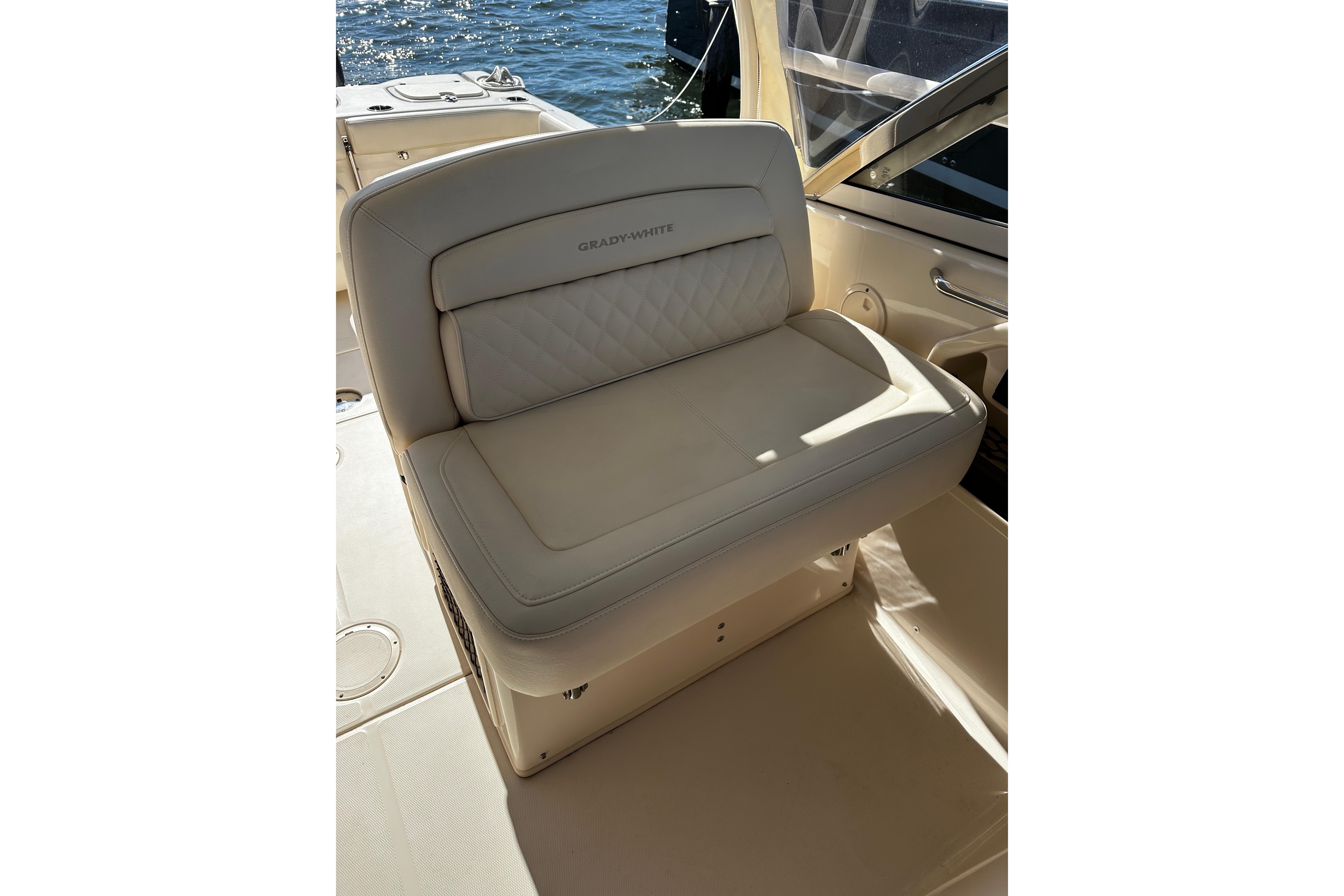 2023 Grady-White Freedom 307 boat seat, beige leather, on deck with water view.