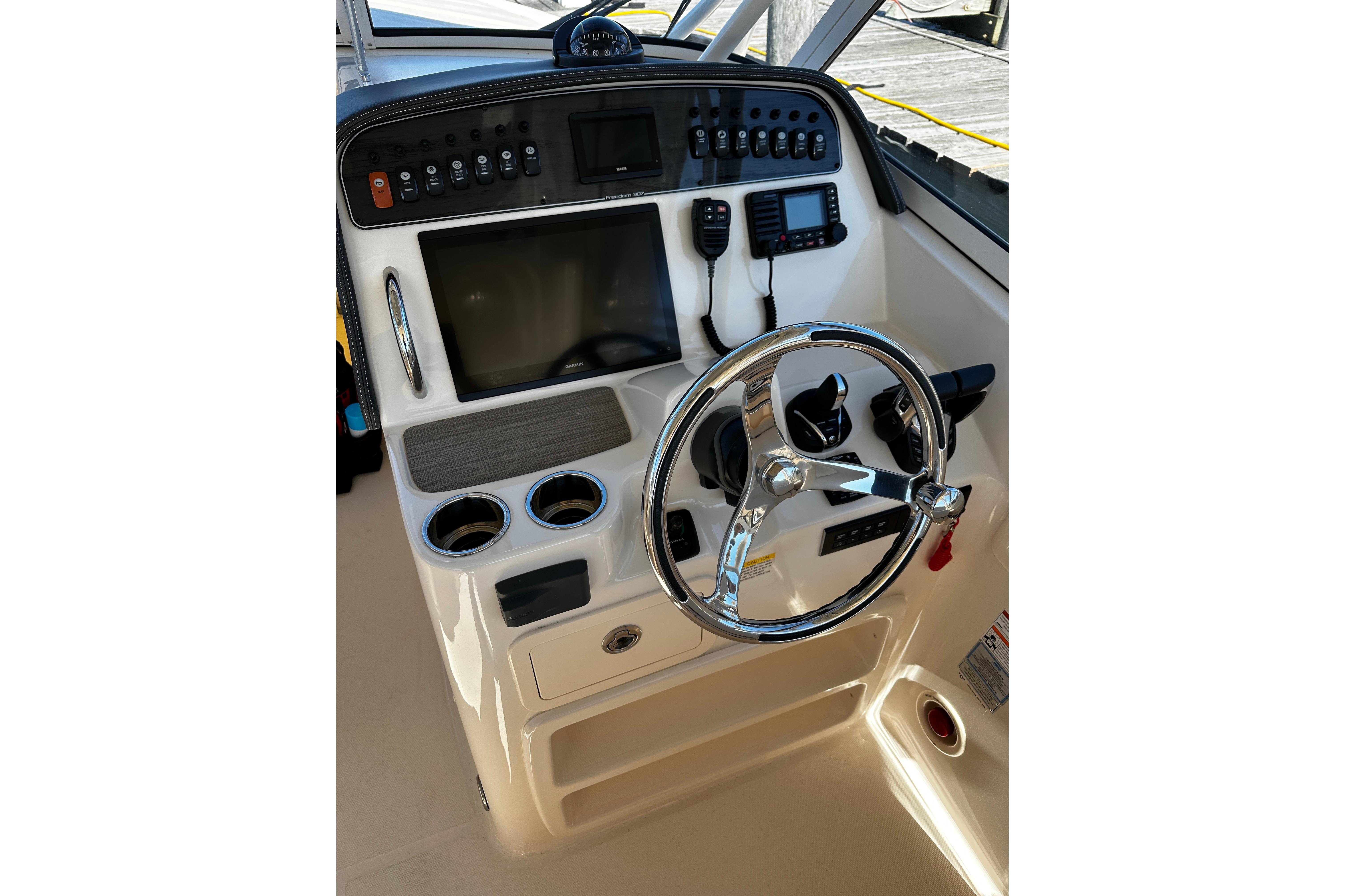 2023 Grady-White Freedom 307 boat dashboard with steering wheel and controls.