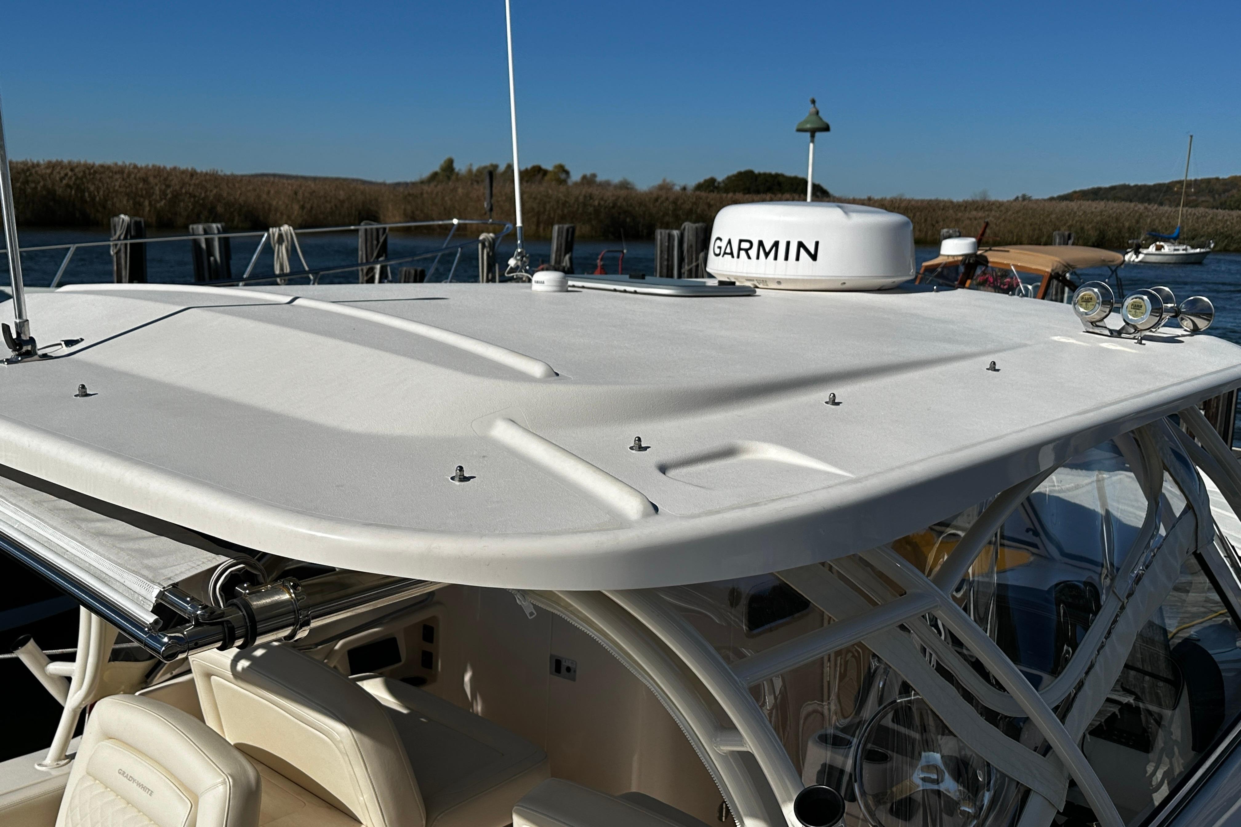 2023 Grady-White Freedom 307 boat with Garmin radar, docked by the water.