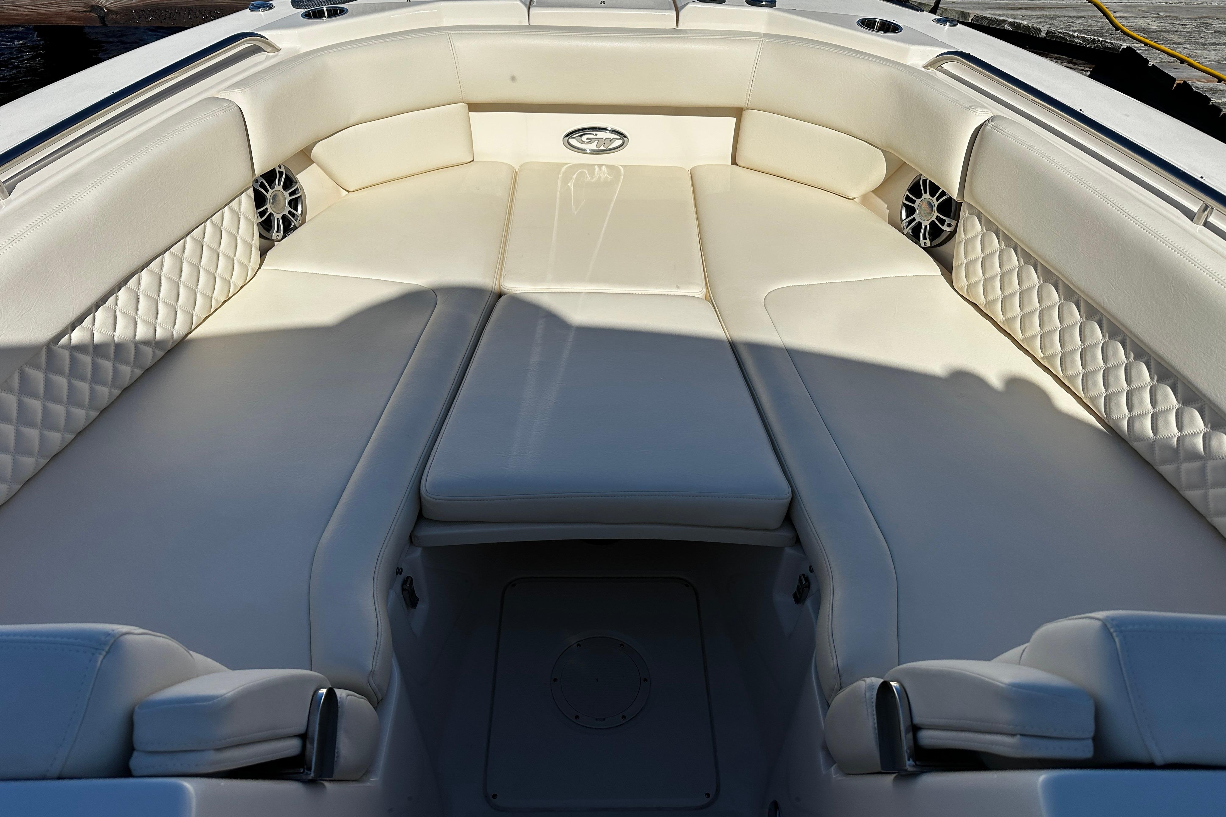 Luxurious seating area on 2023 Grady-White Freedom 307 boat, featuring elegant white upholstery.