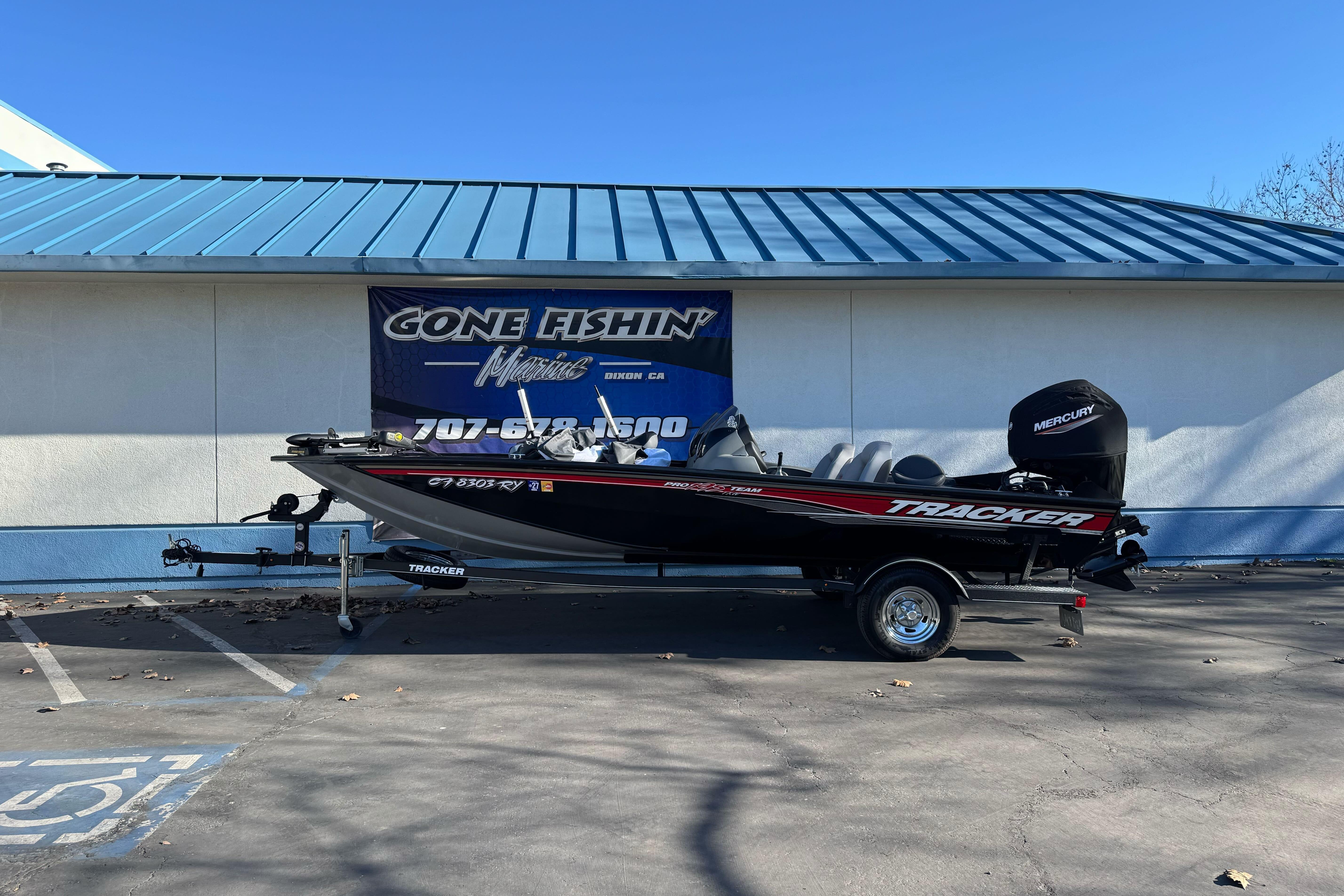 2017 Tracker Pro Team 195 TXW boat parked outside a marine shop.