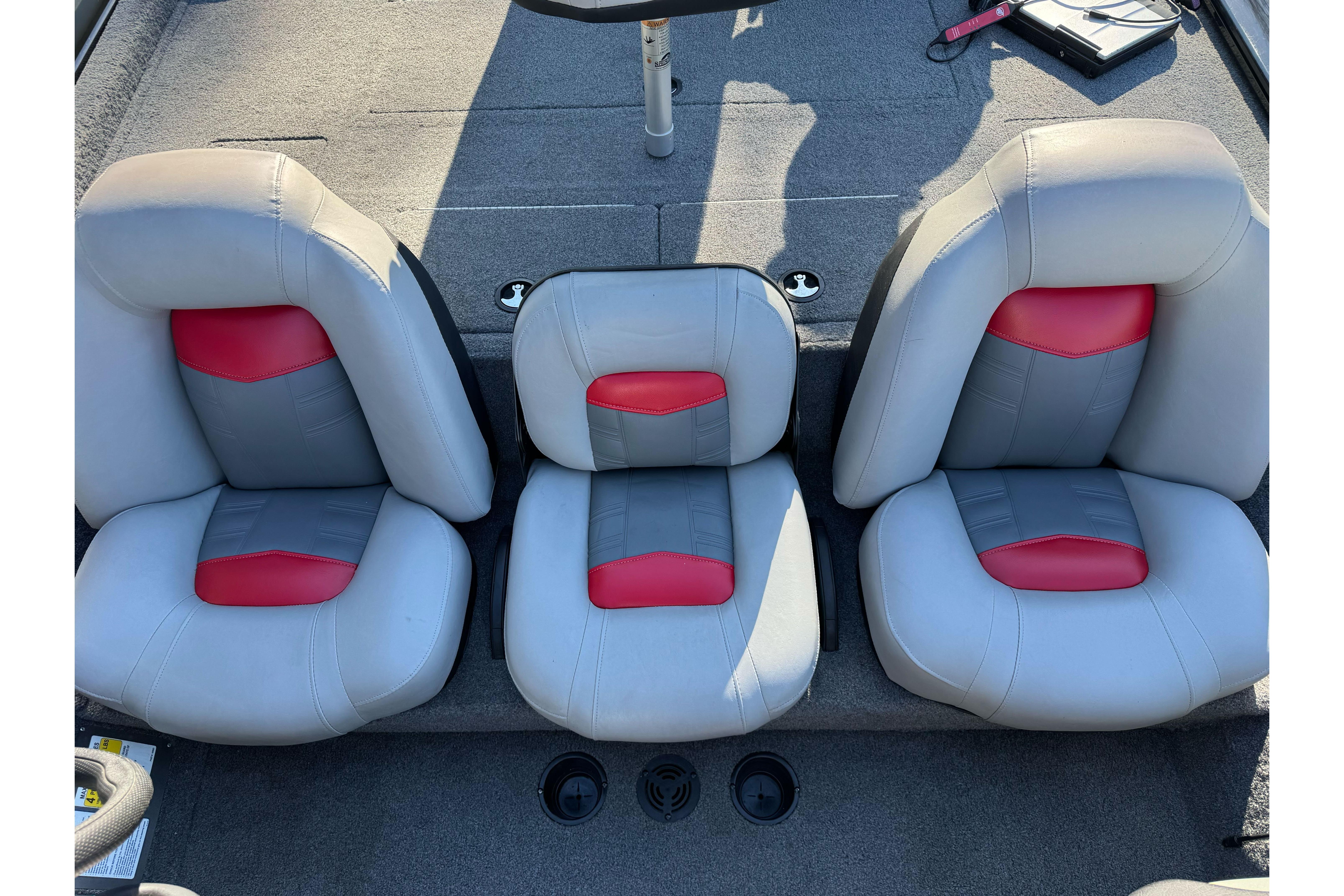2017 Tracker Pro Team 195 TXW boat seats with gray and red upholstery.