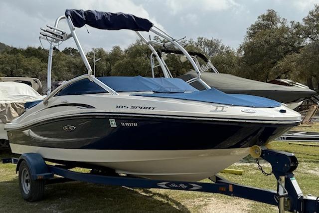 2010 Sea Ray 185 Sport boat on trailer, parked outdoors.