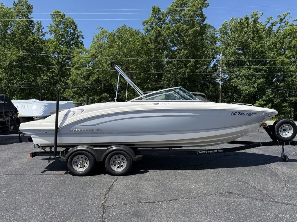 2022 Chaparral 23 SSi boat on trailer, parked outdoors with trees in background.