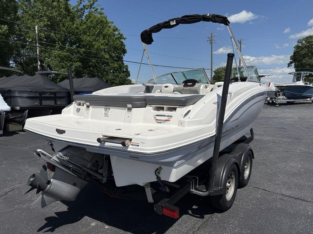 2022 Chaparral 23 SSi boat on trailer, parked outdoors under clear sky.