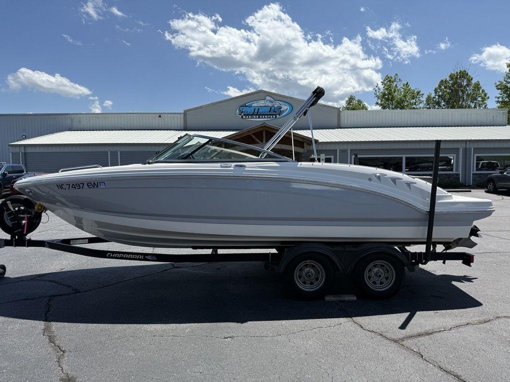 2022 Chaparral 23 SSi boat on trailer, parked outdoors under a clear sky.