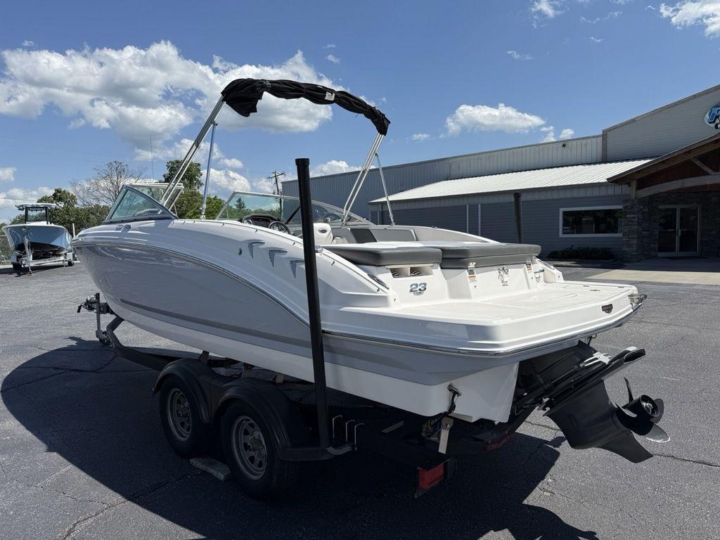 2022 Chaparral 23 SSi boat on trailer, parked outdoors under a clear sky.