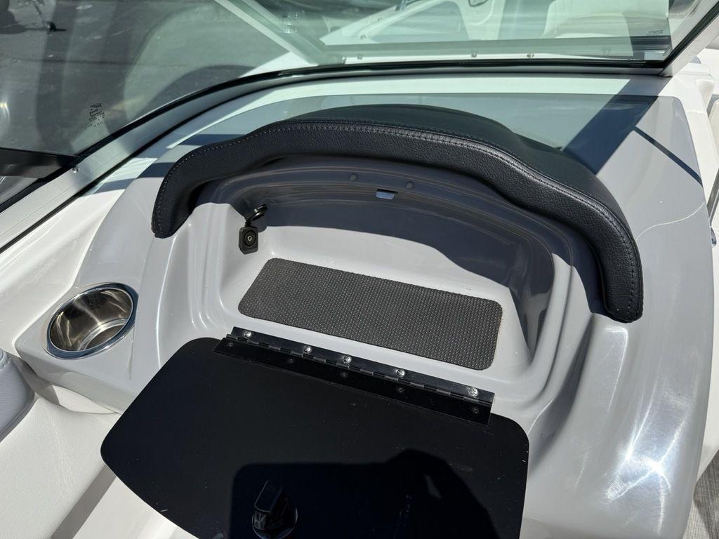 2022 Chaparral 23 SSi boat dashboard with cup holder and storage compartment.