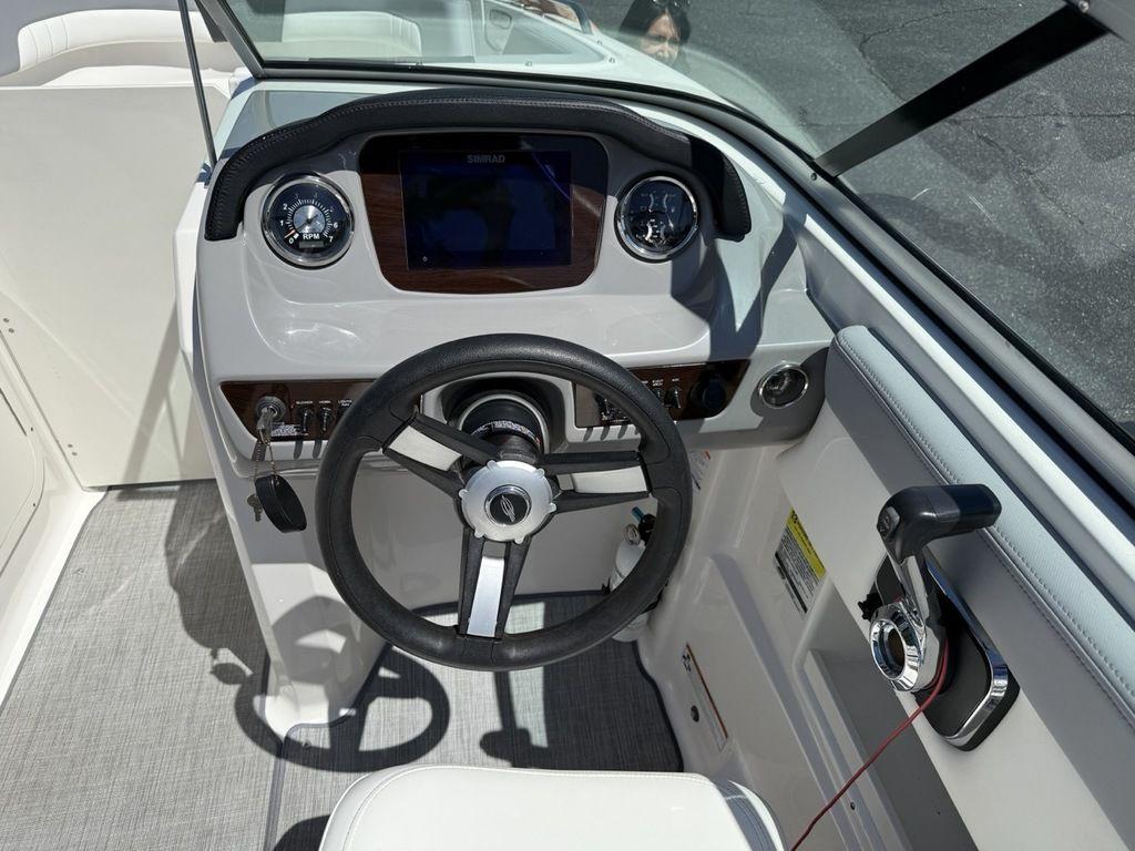 2022 Chaparral 23 SSi boat dashboard with steering wheel and controls.
