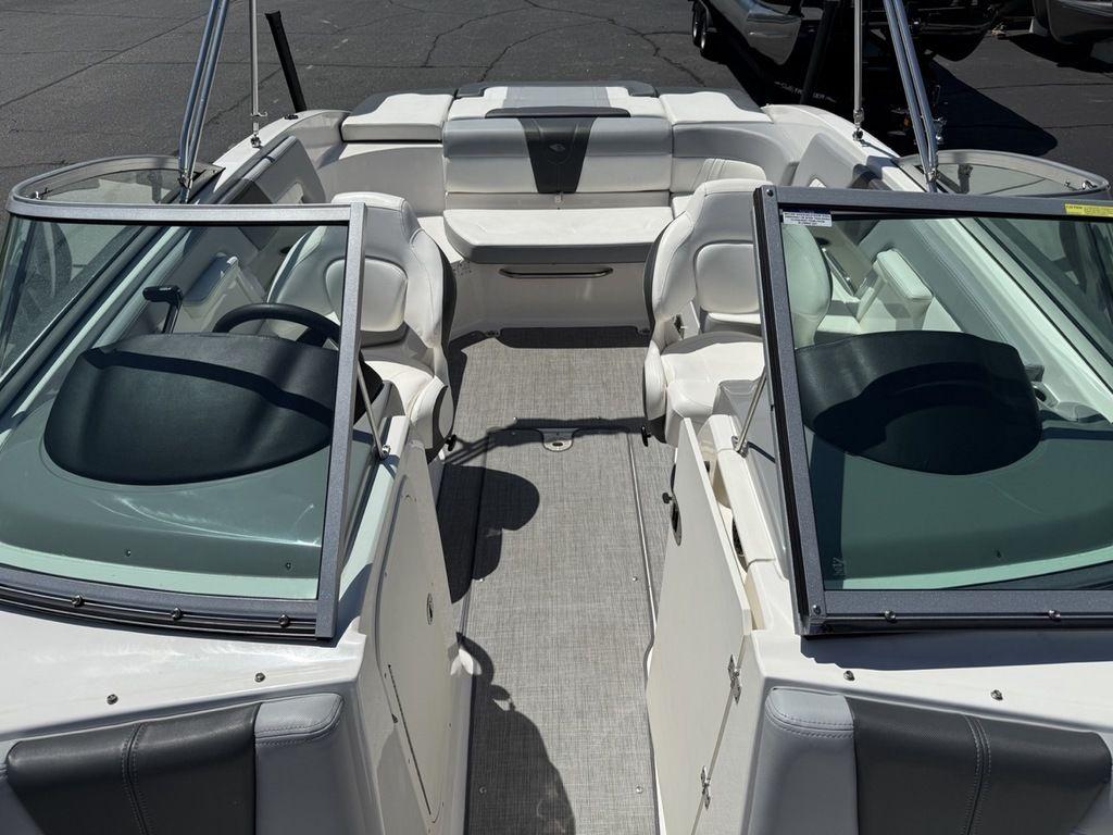 2022 Chaparral 23 SSi boat interior with seating and steering wheel, viewed from above.