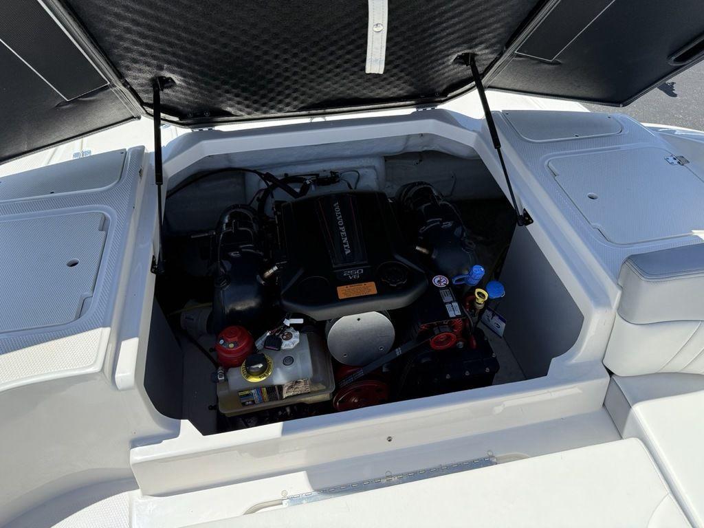 2022 Chaparral 23 SSi boat engine compartment with open hatch, showcasing engine components.