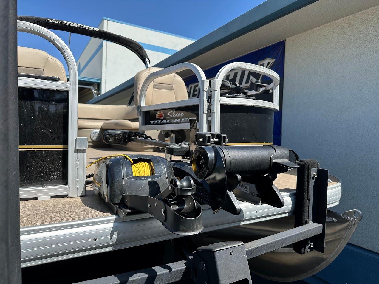 2022 Sun Tracker Bass Buggy 16 XL Select pontoon boat with fishing equipment.