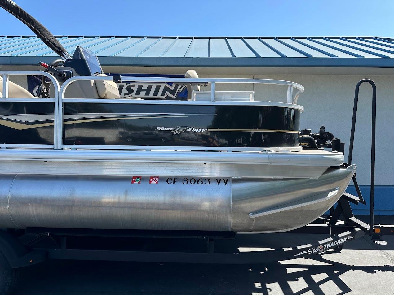 2022 Sun Tracker Bass Buggy 16 XL Select pontoon boat, side view, parked on trailer.