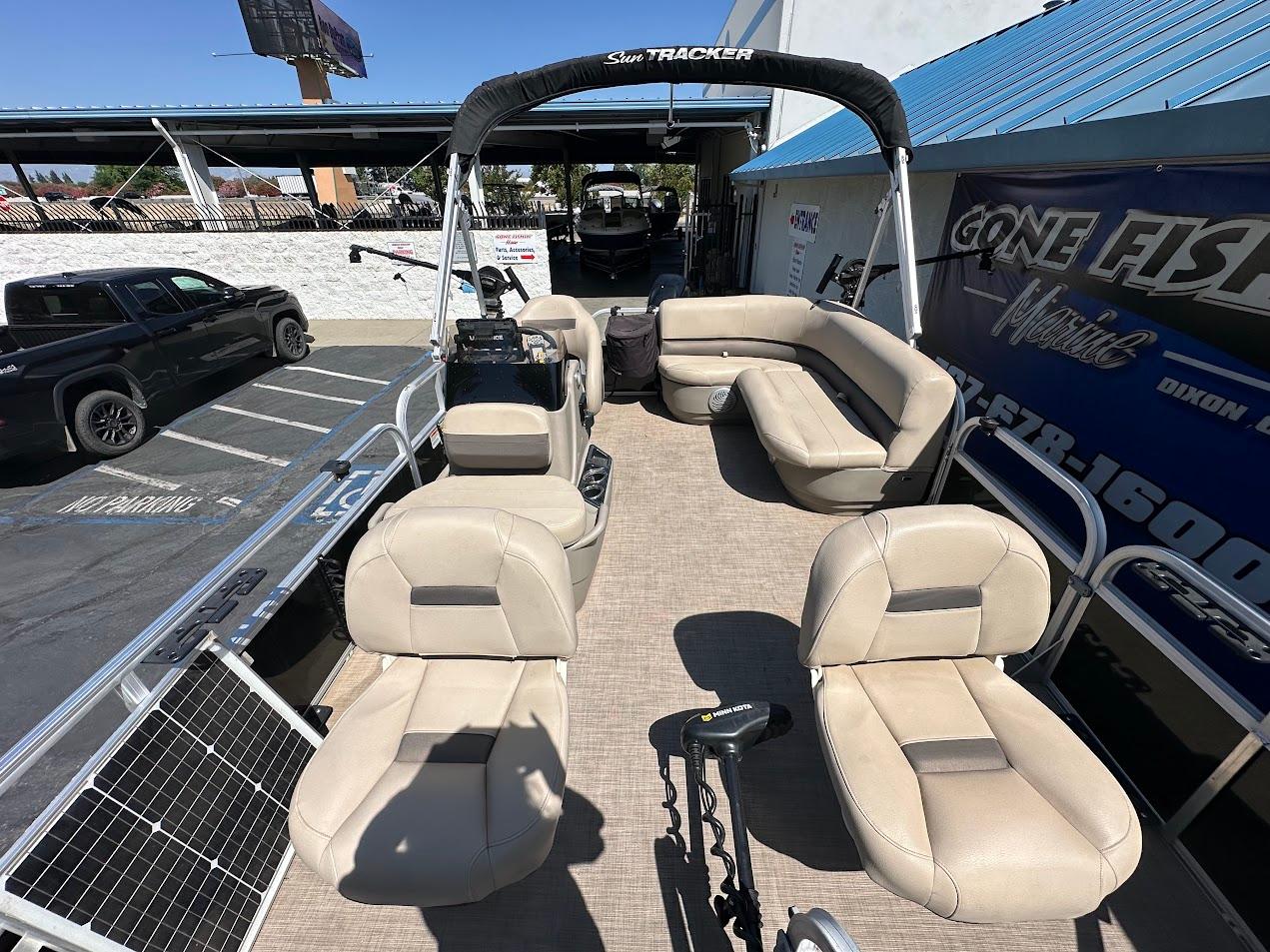 2022 Sun Tracker Bass Buggy 16 XL Select pontoon boat with beige seating and spacious layout.