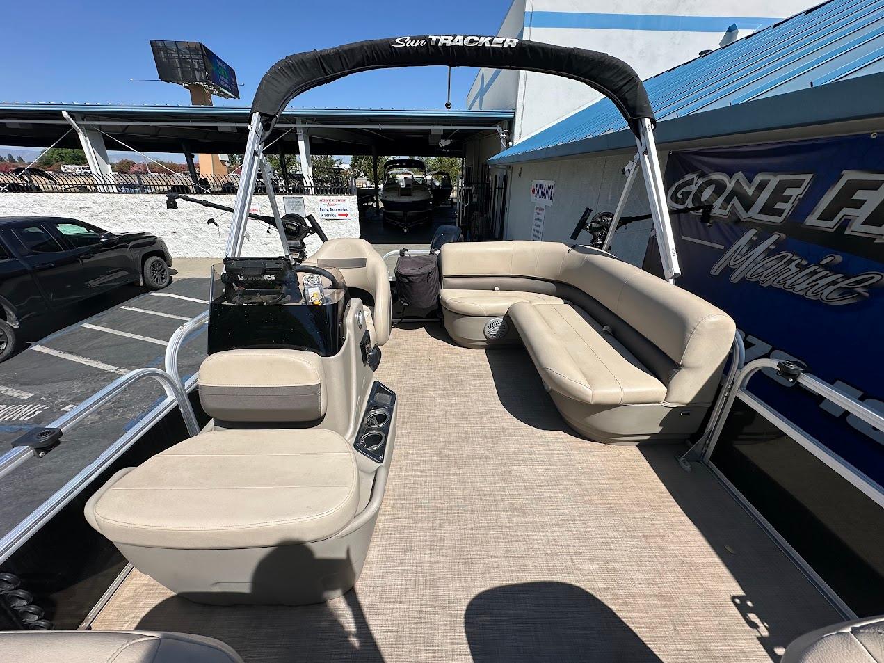 2022 Sun Tracker Bass Buggy 16 XL Select pontoon boat with beige seating and canopy.