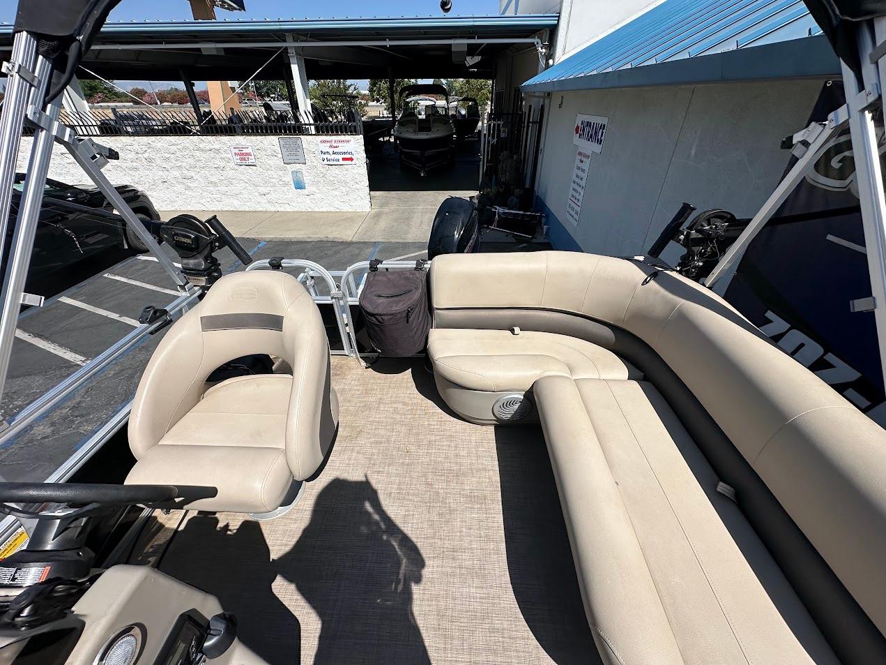 2022 Sun Tracker Bass Buggy 16 XL Select pontoon boat with beige seating and spacious deck.