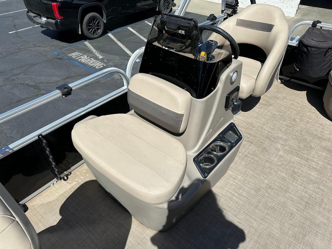 2022 Sun Tracker Bass Buggy 16 XL Select boat interior with beige seating and steering console.