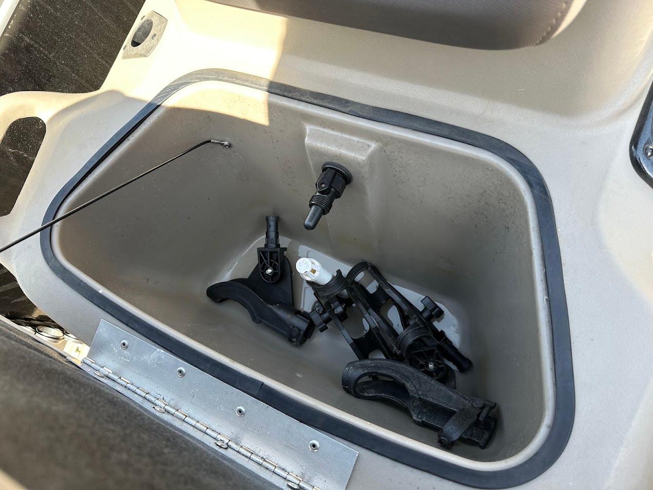 Storage compartment of 2022 Sun Tracker Bass Buggy 16 XL Select with accessories inside.