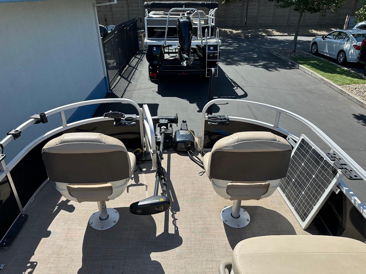 2022 Sun Tracker Bass Buggy 16 XL Select pontoon boat with dual seats and solar panel.