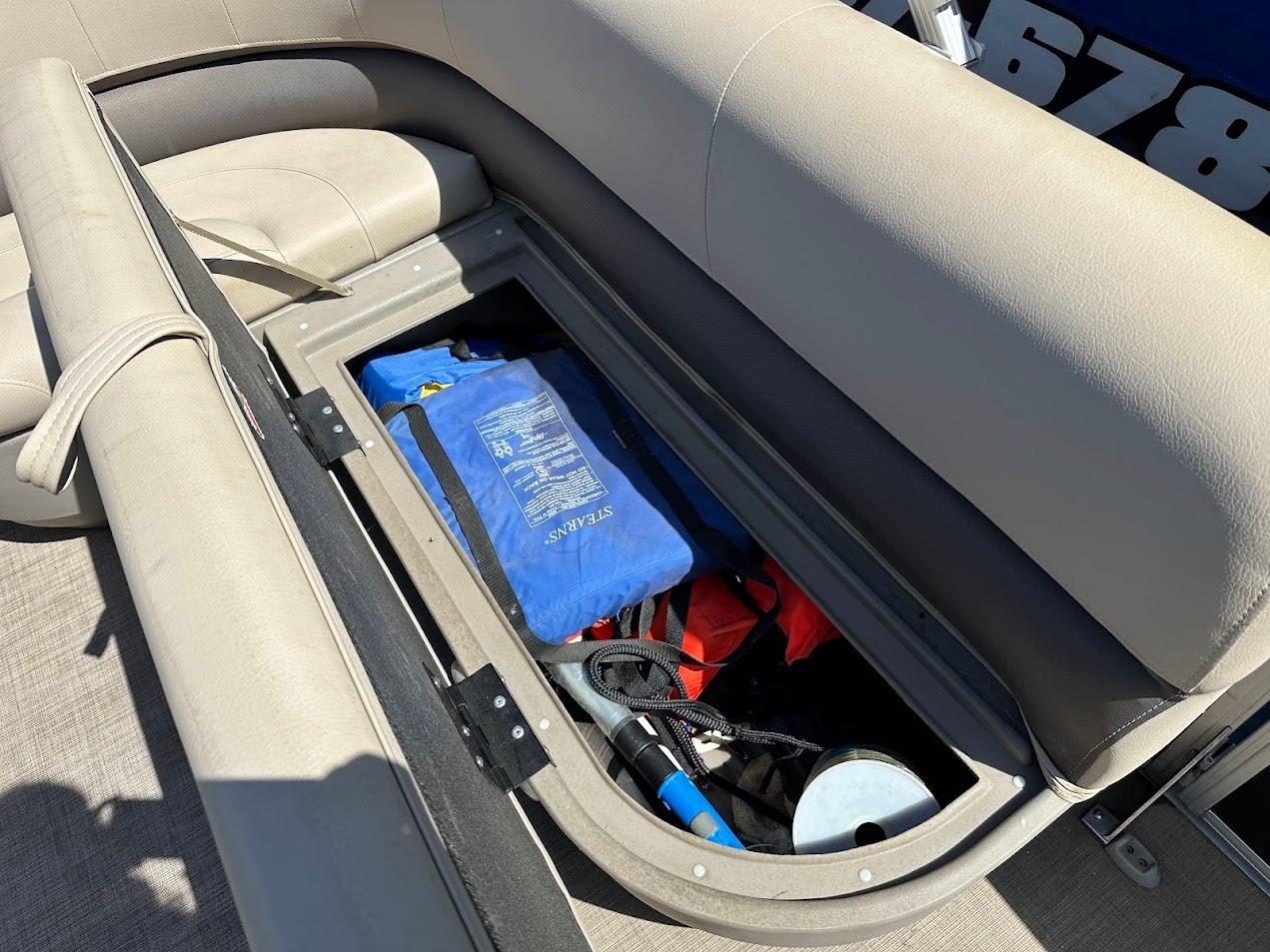 2022 Sun Tracker Bass Buggy 16 XL Select storage compartment with safety gear and accessories.