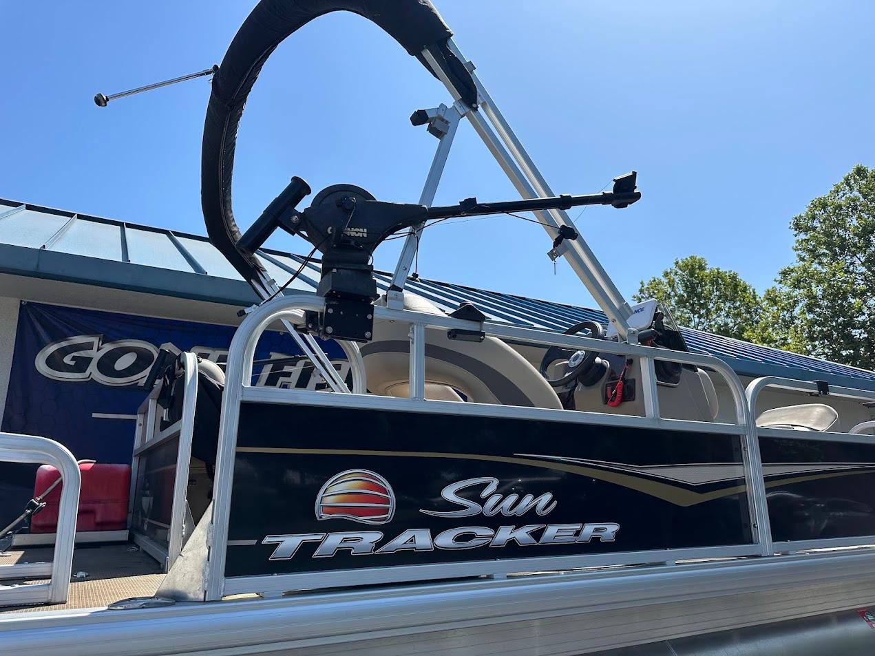 2022 Sun Tracker Bass Buggy 16 XL Select pontoon boat, side view with steering wheel.