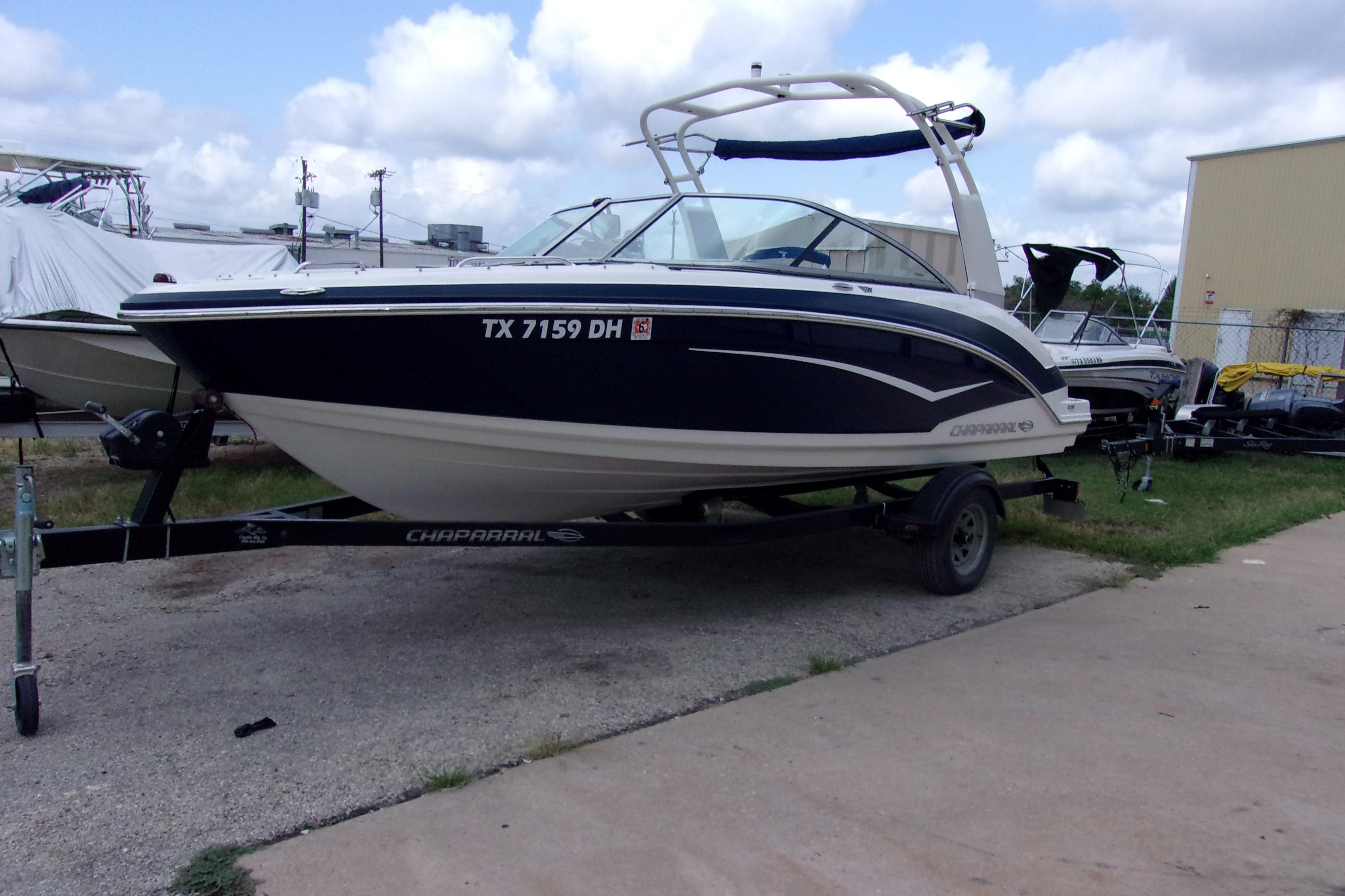 2016 Chaparral Vortex 203 VR boat on trailer, parked outdoors under cloudy sky.