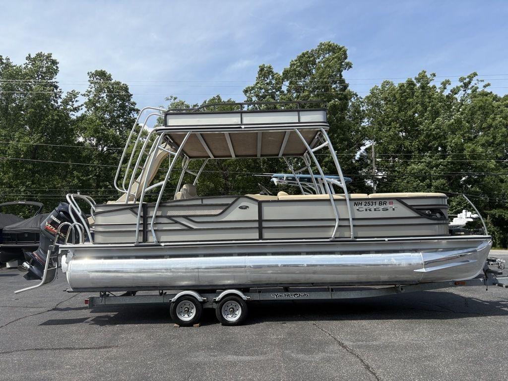 2017 Crest Classic 250L pontoon boat on trailer, parked outdoors.