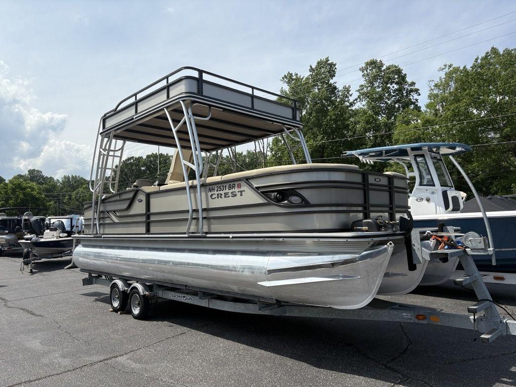 2017 Crest Classic 250L USD CP3 pontoon boat on trailer, parked outdoors.