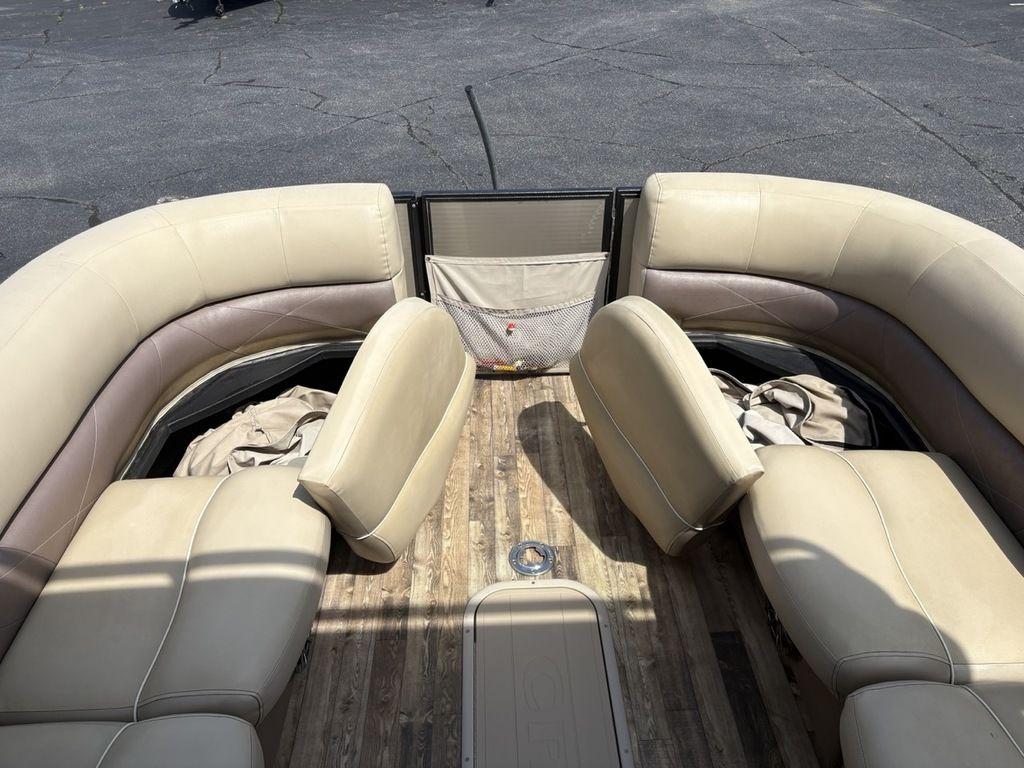 2017 Crest Classic 250L USD CP3 pontoon boat interior with beige seating and wooden floor.