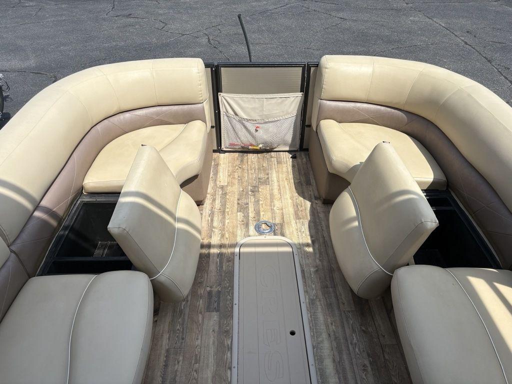 Interior of 2017 Crest Classic 250L USD CP3 pontoon boat with beige seating and wood flooring.