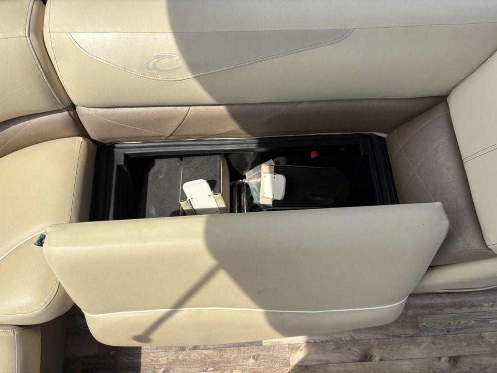 2017 Crest Classic 250L USD CP3 boat seat storage compartment open, revealing interior components.