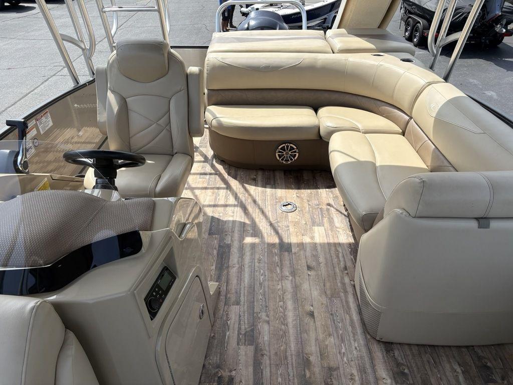2017 Crest Classic 250L USD CP3 pontoon boat interior with beige seating and wood-style flooring.