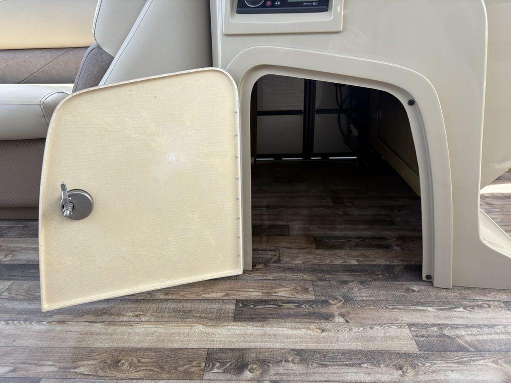 Open storage compartment on 2017 Crest Classic 250L USD CP3 boat with wood-patterned flooring.